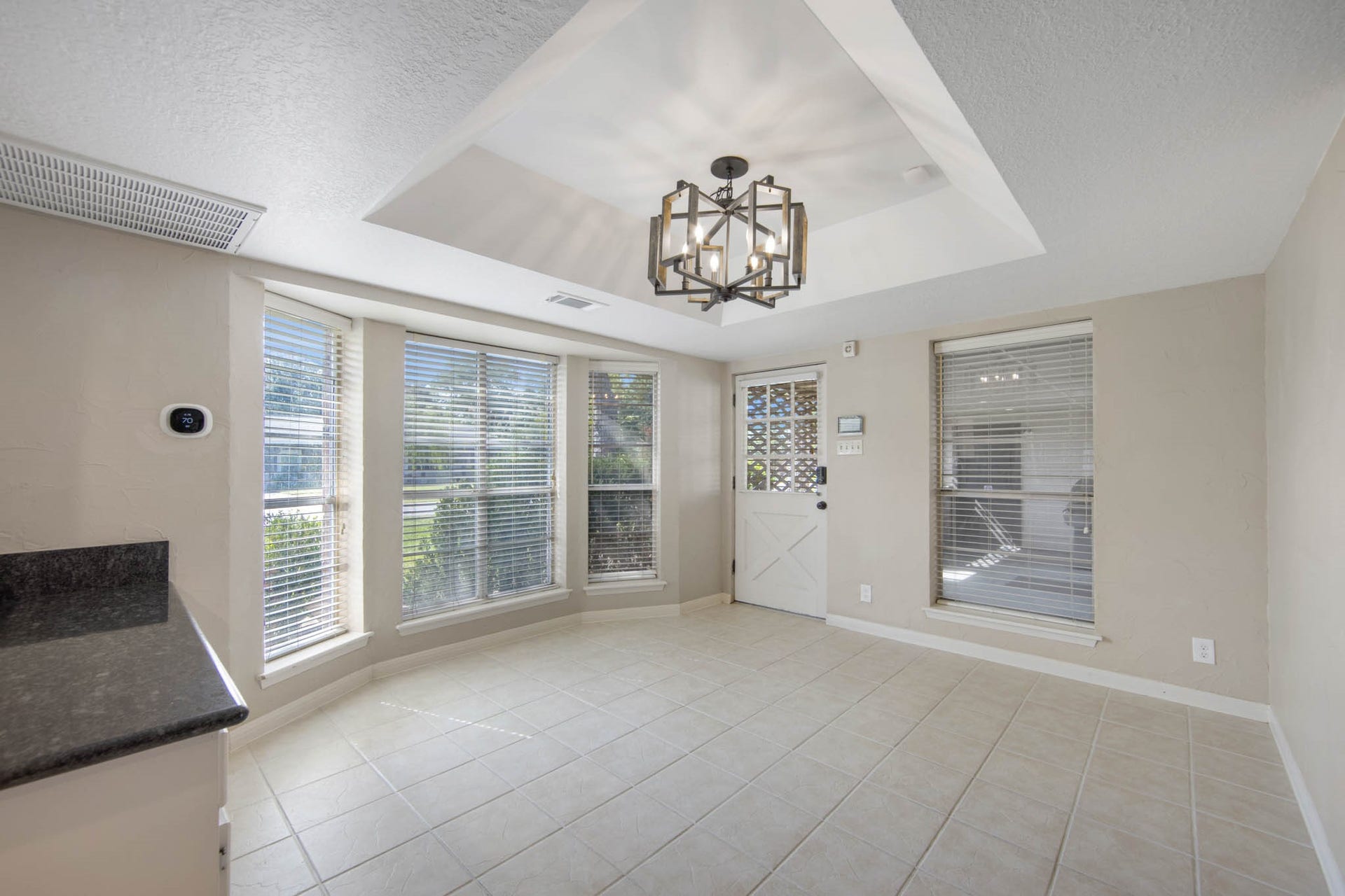 Dining Room with tray ceiling and tile floors