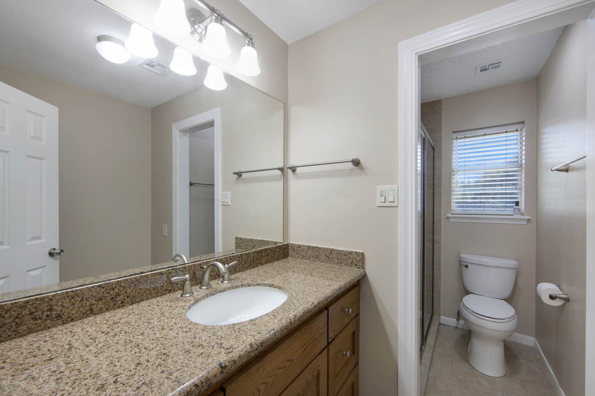 Secondary bath with enclosed toilet for privacy