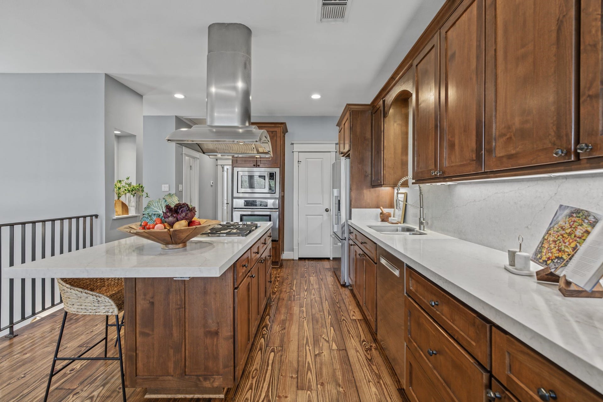 1517 Blair Street, Houston, TX 77008 The kitchen features stainless steel appliances, a gas cooktop, a new Fisher & Paykel microwave (June 2026), and a spacious island with seating.
