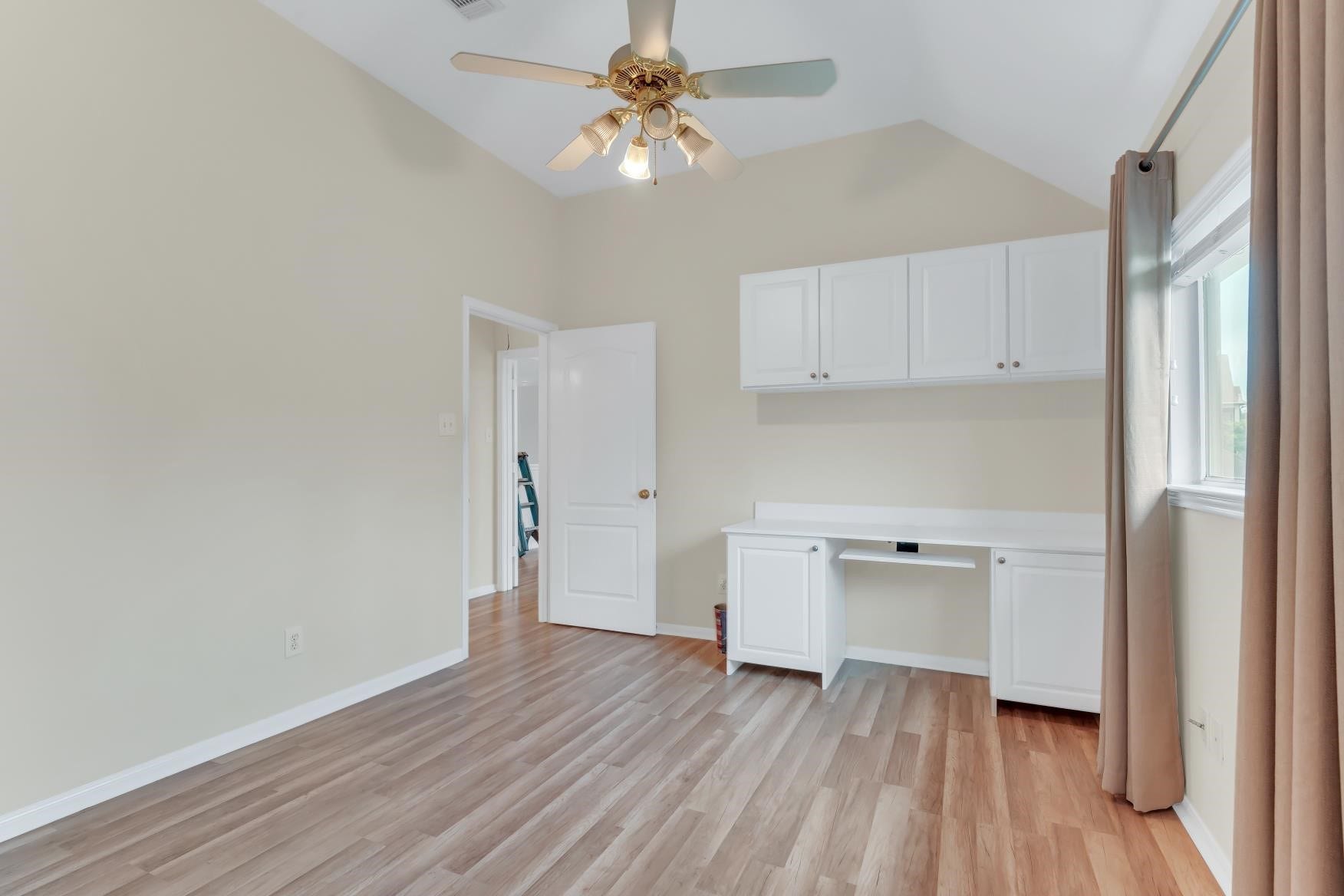 1st bedroom with built-in cabinates, Laminate flooring, ceiling fan