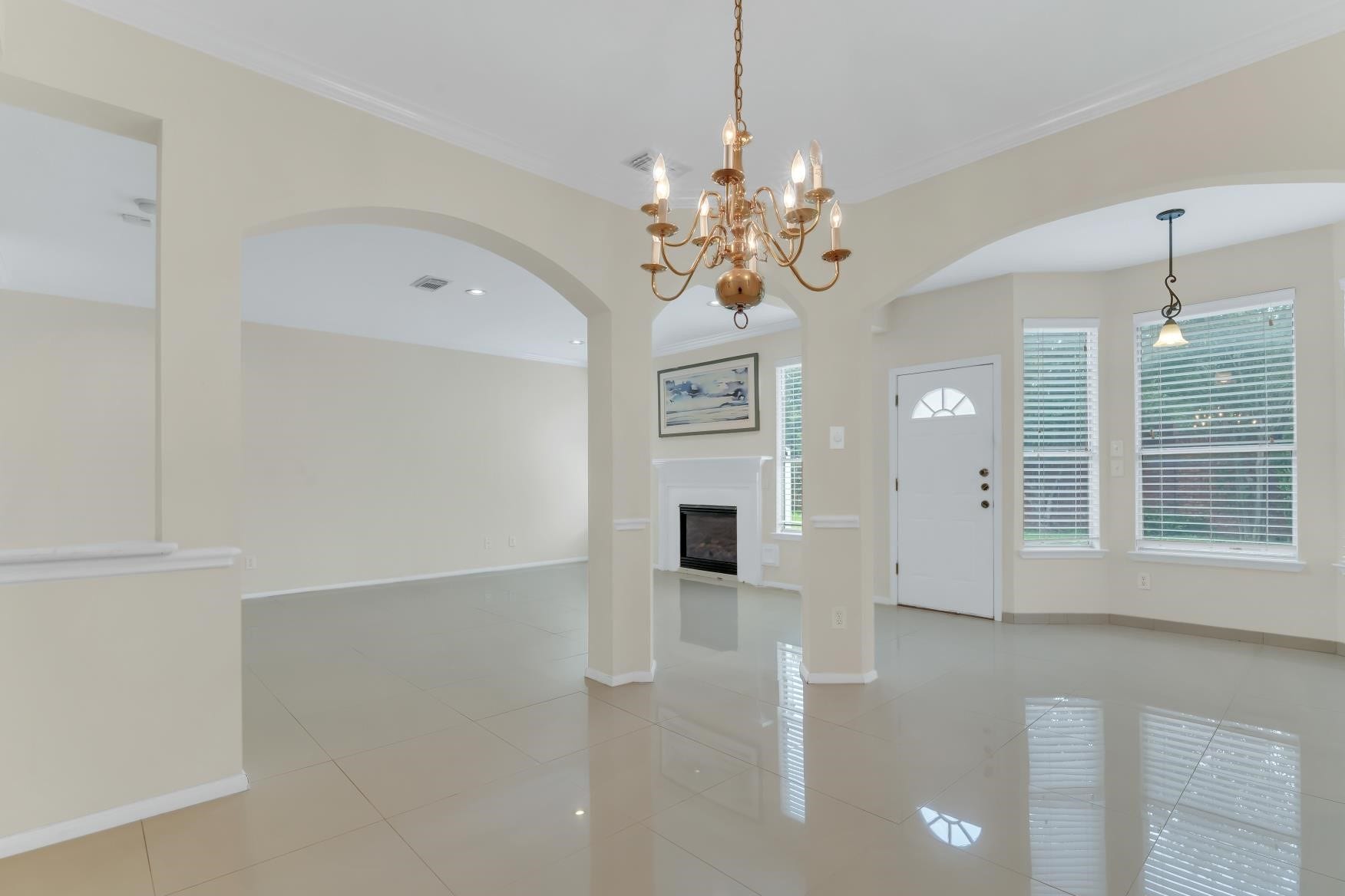 Bright, Spacious open concept living with stunning tile floor and soaring ceiling, View of the backyard.