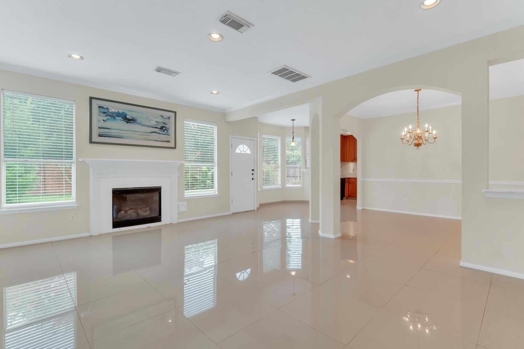 Wall of windows, high ceiling open living area.