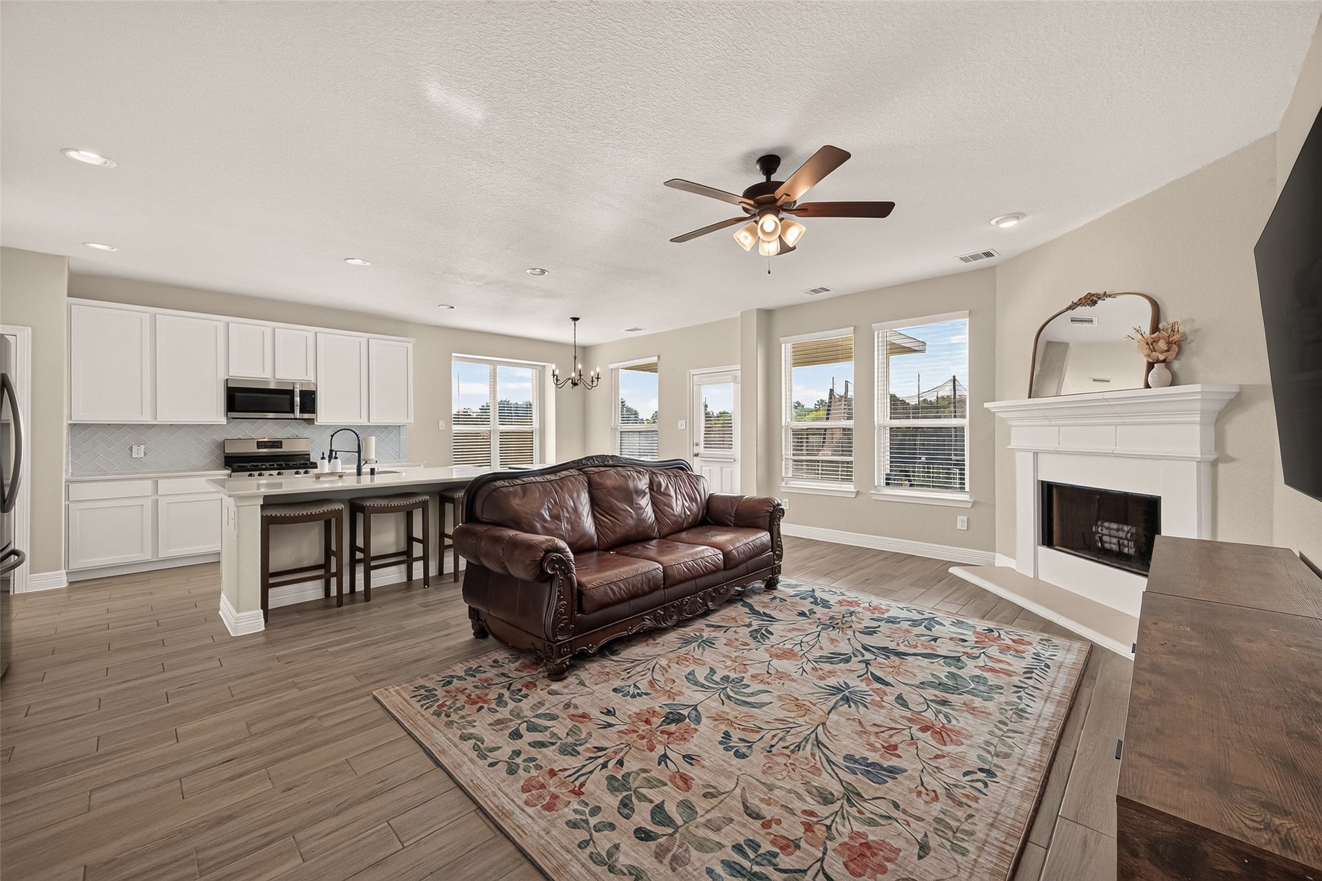 3603 Gentle Meadow Drive, Richmond, TX 77406 Open floor plan living area with cozy corner fire place and abundant natural light