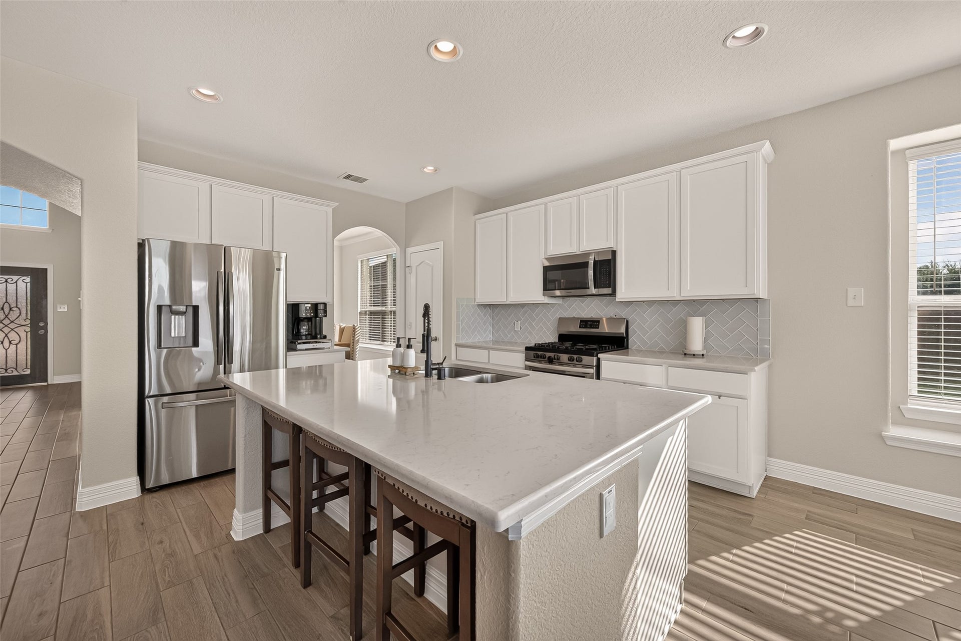 3603 Gentle Meadow Drive, Richmond, TX 77406 White painted cabinets, stainless appliances, designer backsplash make it a joy to prepare gatherings