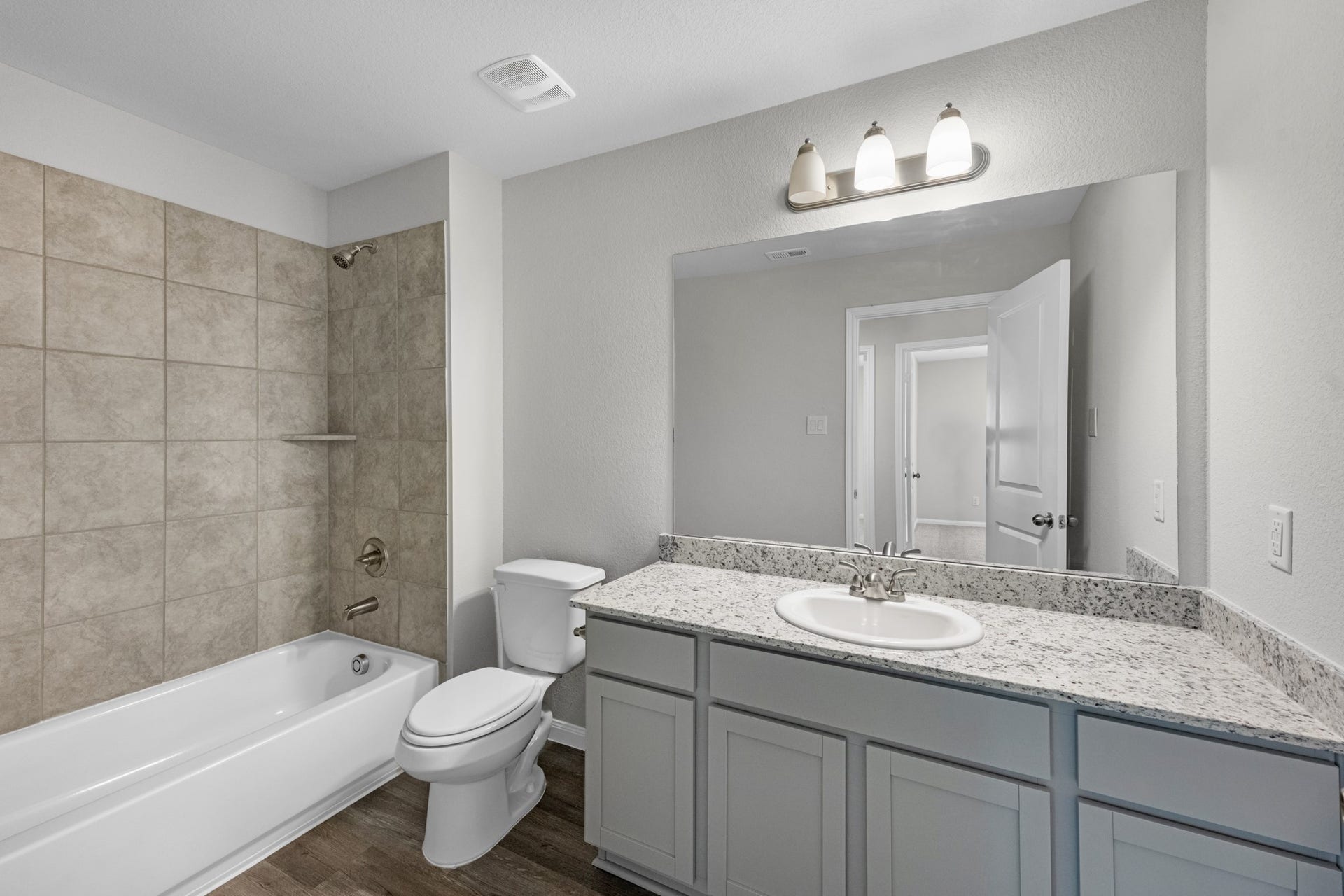 26439 Lakeshore Drive, Hempstead, TX 77445 A shared full bathroom between the 2 guest bedrooms offers granite countertops, additional storage cabinets, and a tub/shower combo with tile surround.