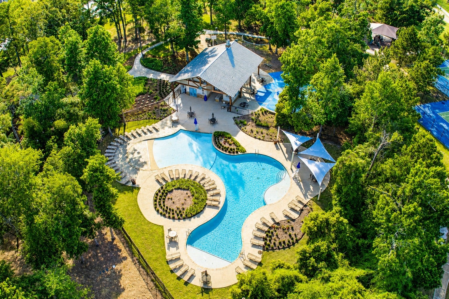 3622 Sage Hollow Drive, Spring, TX 77386 Resort-style living awaits with this beautifully designed community pool, surrounded by towering trees, shaded gathering areas, walking trails, and additional recreation amenities for residents to enjoy year-round.