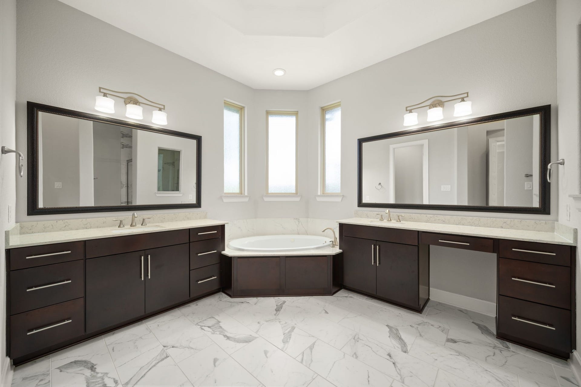 3622 Sage Hollow Drive, Spring, TX 77386 The primary ensuite bathroom, exquisitely appointed with a relaxing drop-in jetted tub, custom tile flooring, a dedicated makeup vanity space, and separate double-sink vanities.