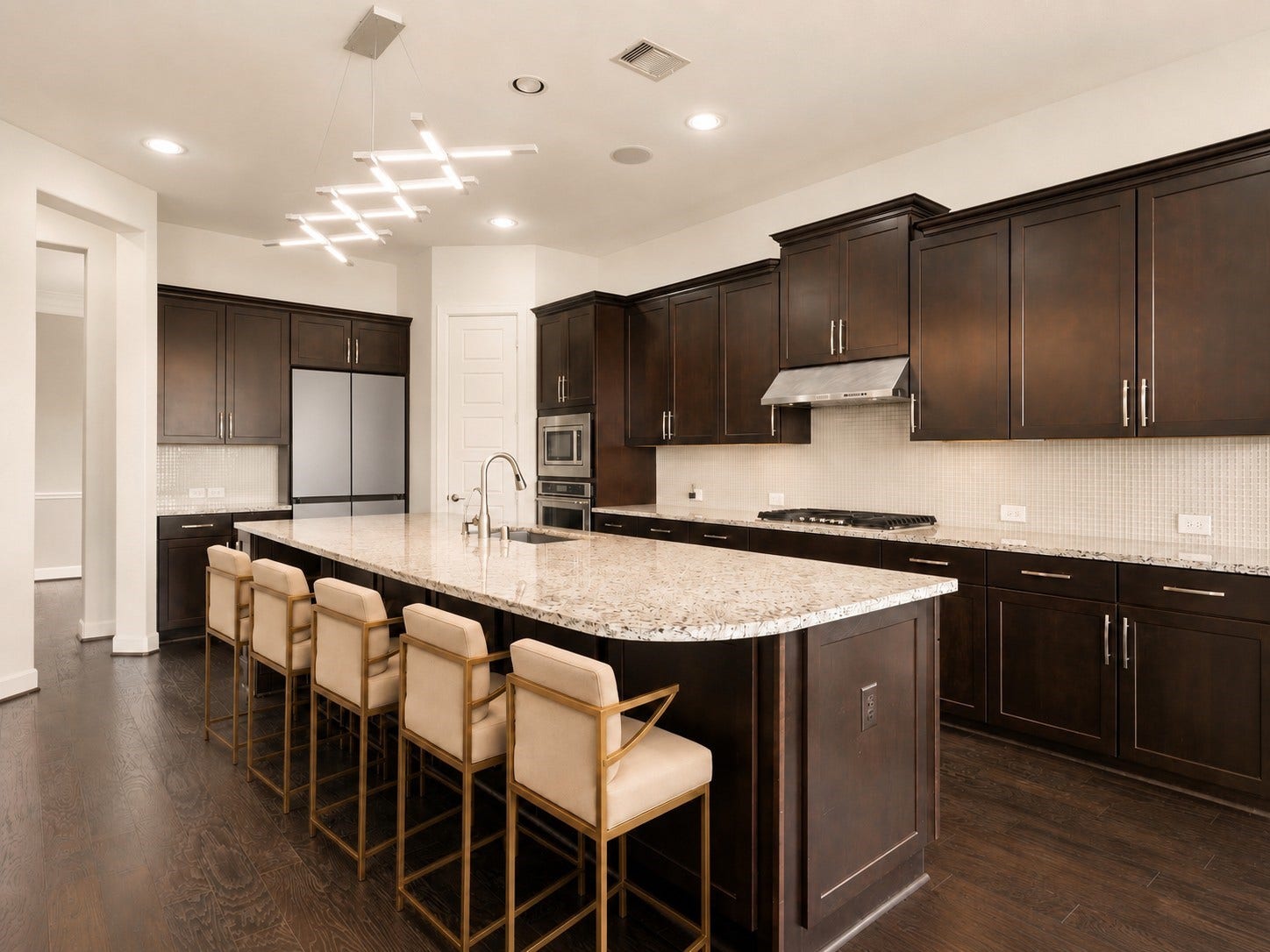 3622 Sage Hollow Drive, Spring, TX 77386 Designed with a premium minimalist feel, this gourmet workspace showcases sleek, full-height Lucente gloss glass tile backsplashes, built-in KitchenAid stainless steel appliances, and premium dark Java cabinetry. Virtually staged.