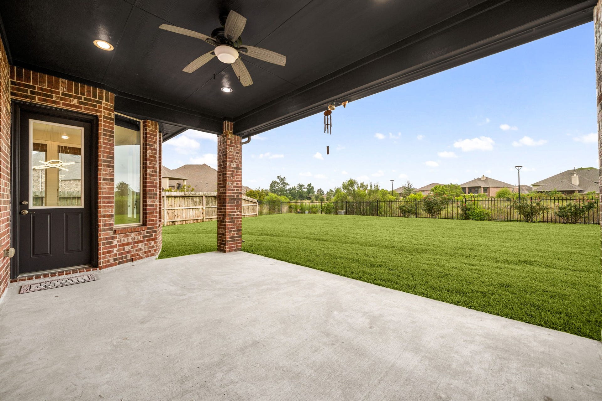 3622 Sage Hollow Drive, Spring, TX 77386 The outdoor pavilion features a convenient exterior door transition into the breakfast area, providing an incredible setup for weekend barbecues and seamless indoor-outdoor entertaining against a backdrop of open green space.