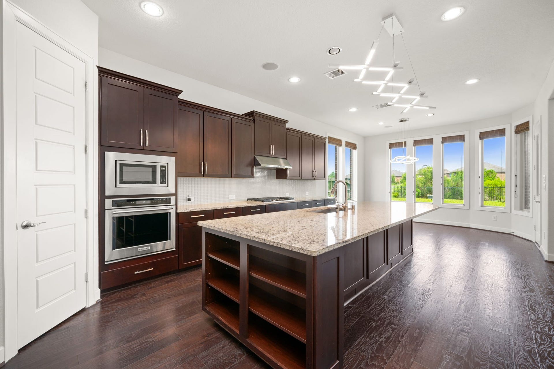 3622 Sage Hollow Drive, Spring, TX 77386 The kitchen centers around an incredible, oversized granite island that offers extensive counter space for food prep and casual dining beneath contemporary multi-bar LED pendant light fixtures.