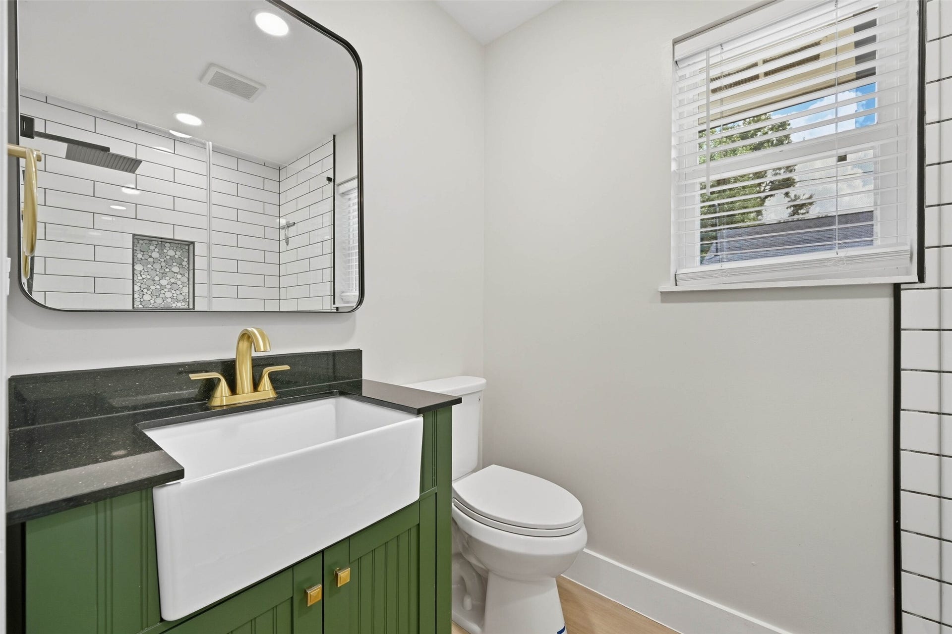 10930 White Thorn Street, #B, Houston, TX 77016 A beautifully designed bathroom includes a farmhouse sink and modern hardware for a polished, sophisticated finish.