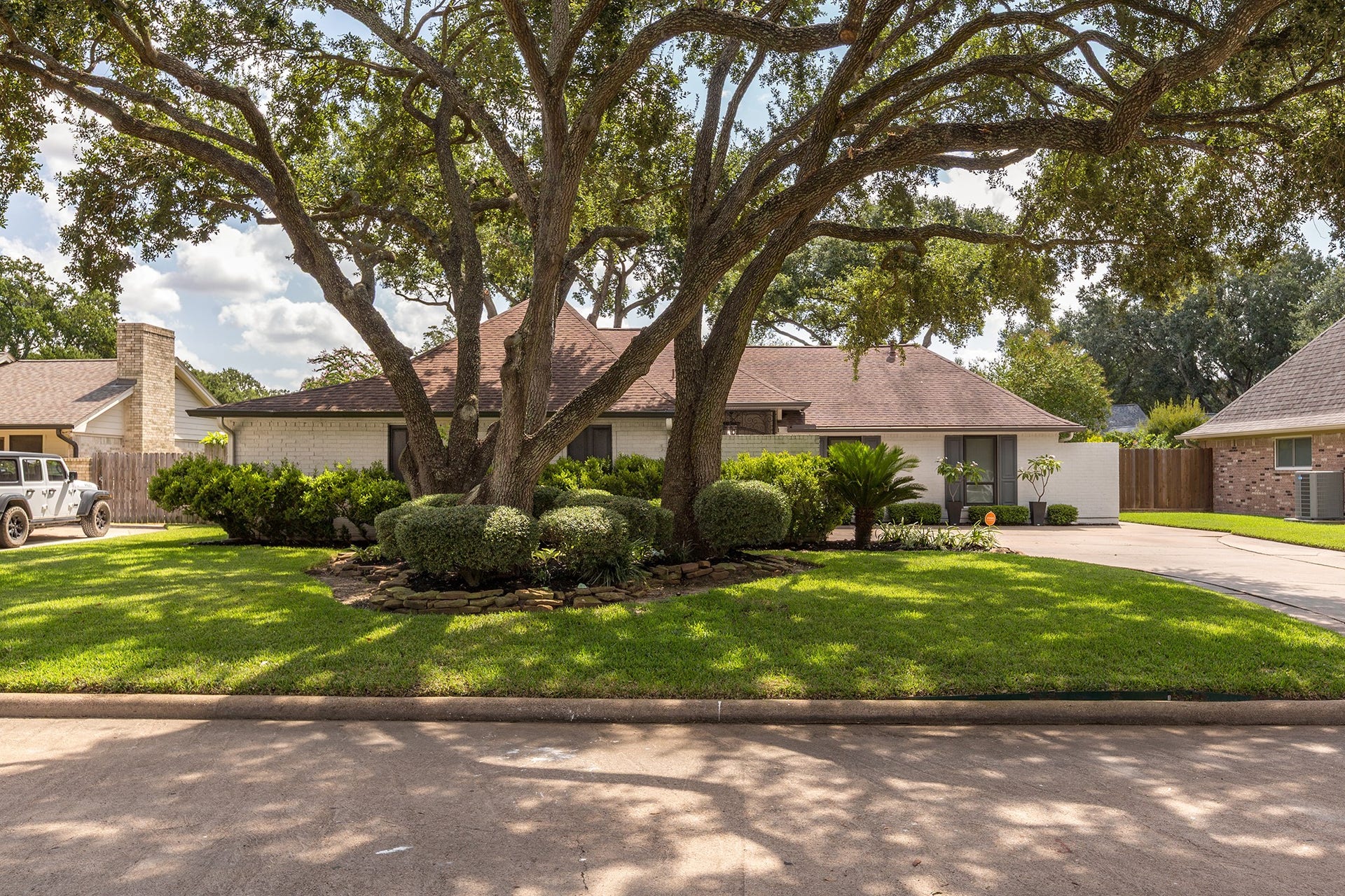 906 Eva Drive, Katy, TX 77493 Mature and well manicured trees shade this wonderful front yard