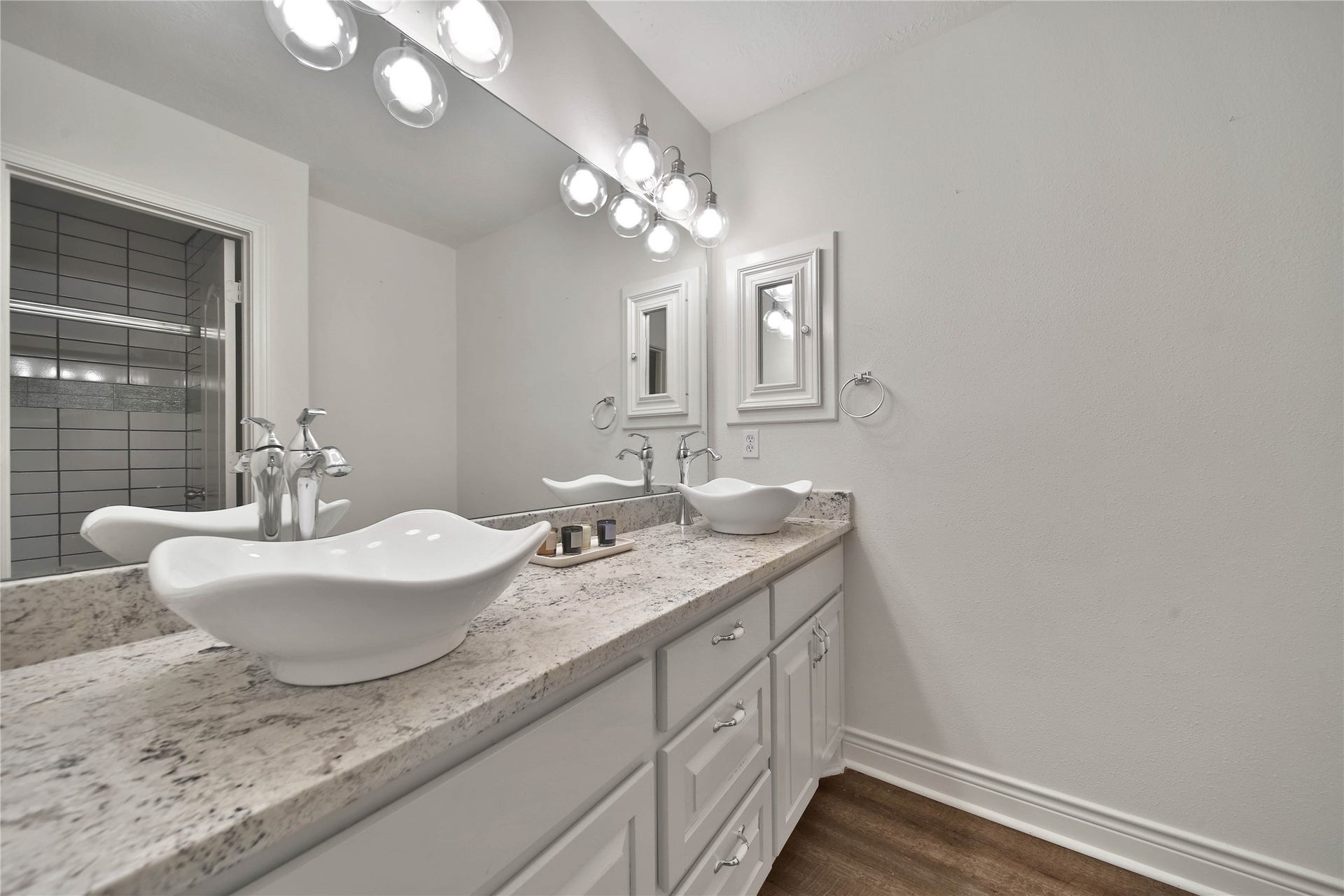 5918 Greenway Manor Lane, Spring, TX 77373 Secondary bathroom features doble vessel sinks, a spacious vanity with ample storage and a glass enclosed shower.