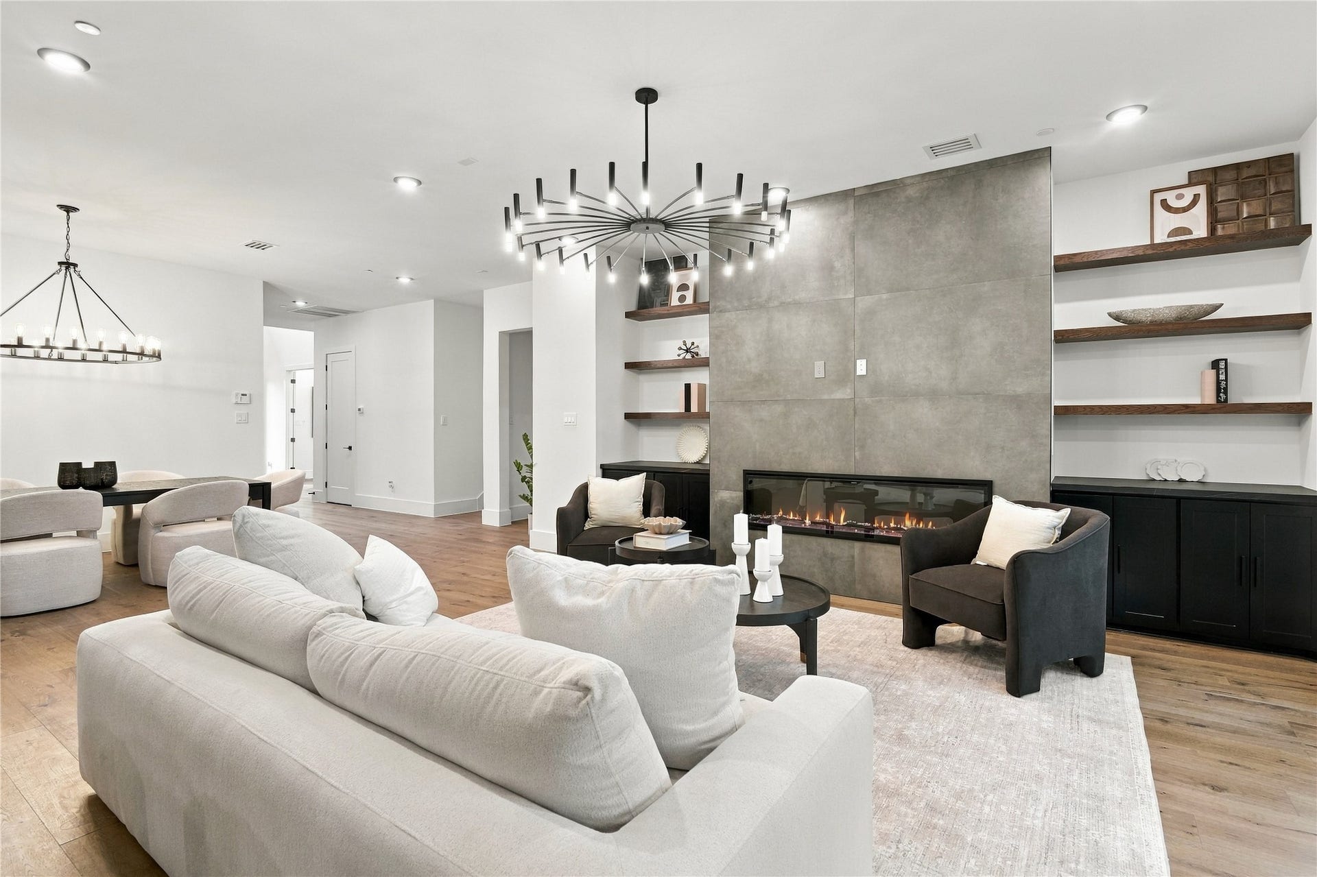 4629 Pine Street, Bellaire, TX 77401 Elegant living room featuring a statement chandelier, neutral tones, and a spacious open-concept layout.