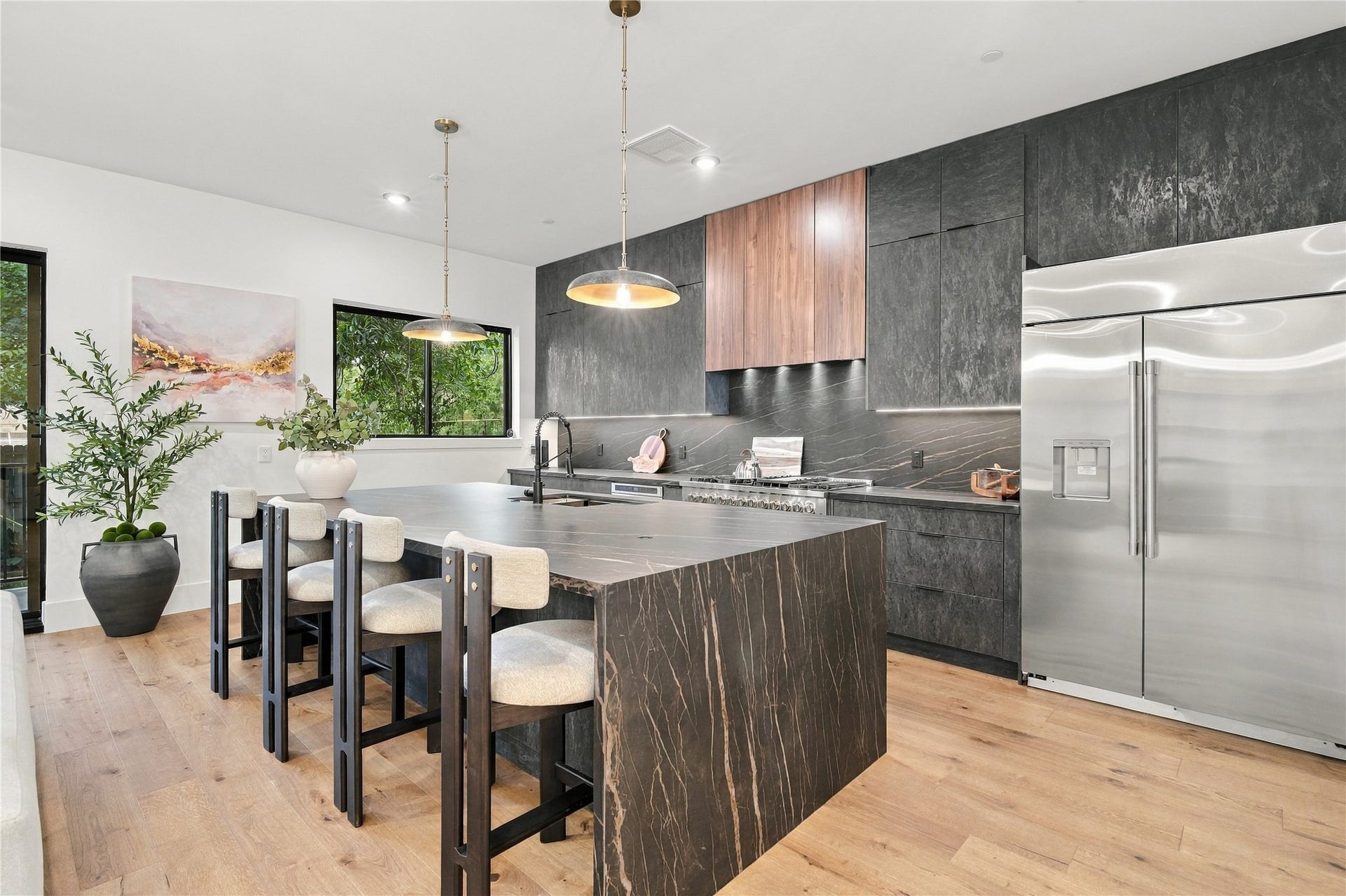 4629 Pine Street, Bellaire, TX 77401 Open-concept kitchen and dining area featuring a large island, designer lighting, and sophisticated finishes.