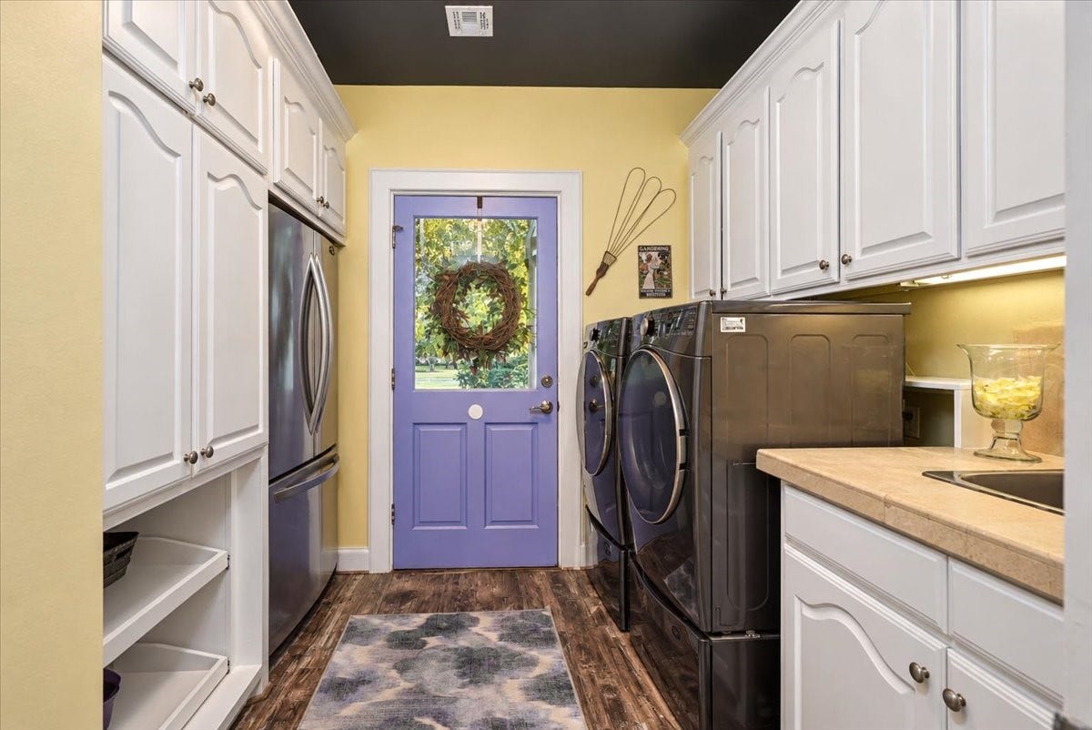 8514 Haven Way, Tomball, TX 77375 Well-organized laundry room with a sink and ample storage, a practical space for everyday routines.