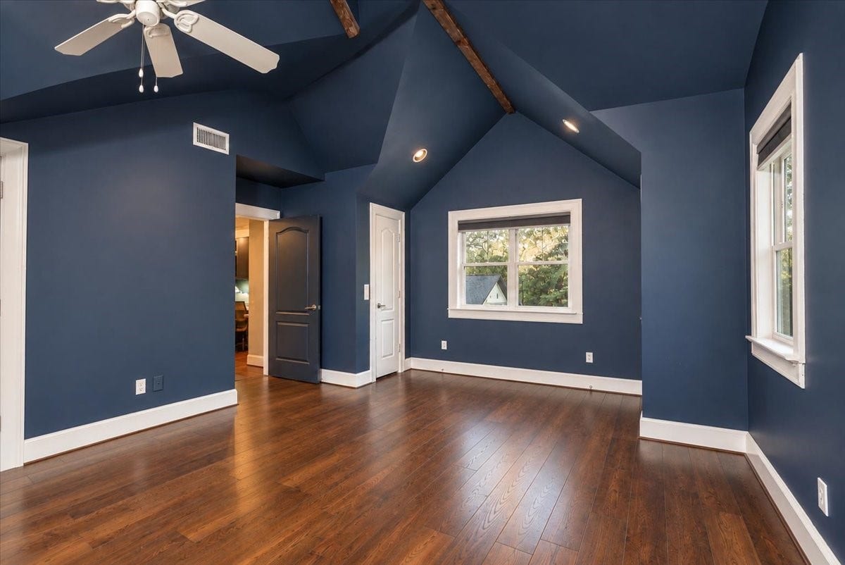 8514 Haven Way, Tomball, TX 77375 Spacious upstairs bedroom with an open, airy feel, thanks to high ceilings, exposed beam accents, and plenty of natural light.