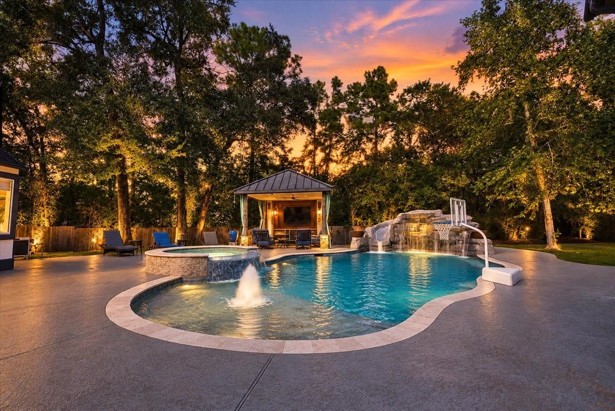 8514 Haven Way, Tomball, TX 77375 Come home to your own resort-style backyard, where color-changing pool lights, a waterfall slide, and a covered lounge area make every evening feel like an occasion.