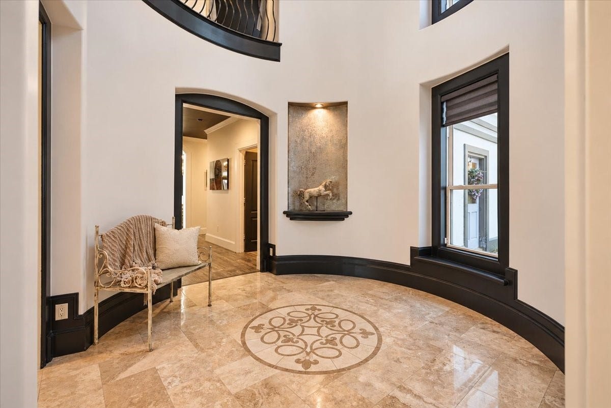 8514 Haven Way, Tomball, TX 77375 Step into a grand first impression in this dramatic rotunda foyer, highlighted by elegant travertine flooring and a decorative medallion inlay.