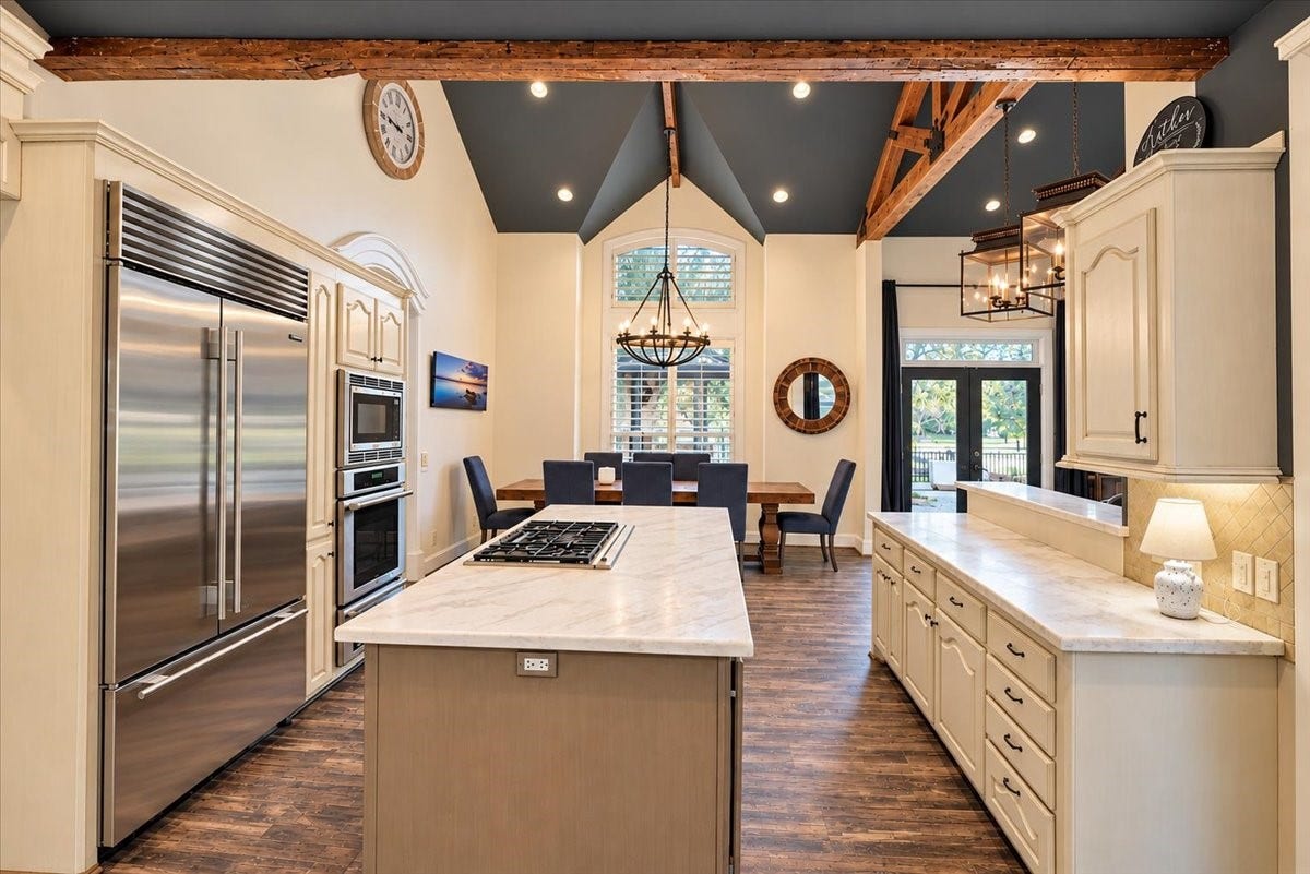 8514 Haven Way, Tomball, TX 77375 A gas cooktop on the island, double wall ovens, and a Sub-Zero refrigerator keep everything within reach, with the breakfast area just steps away.