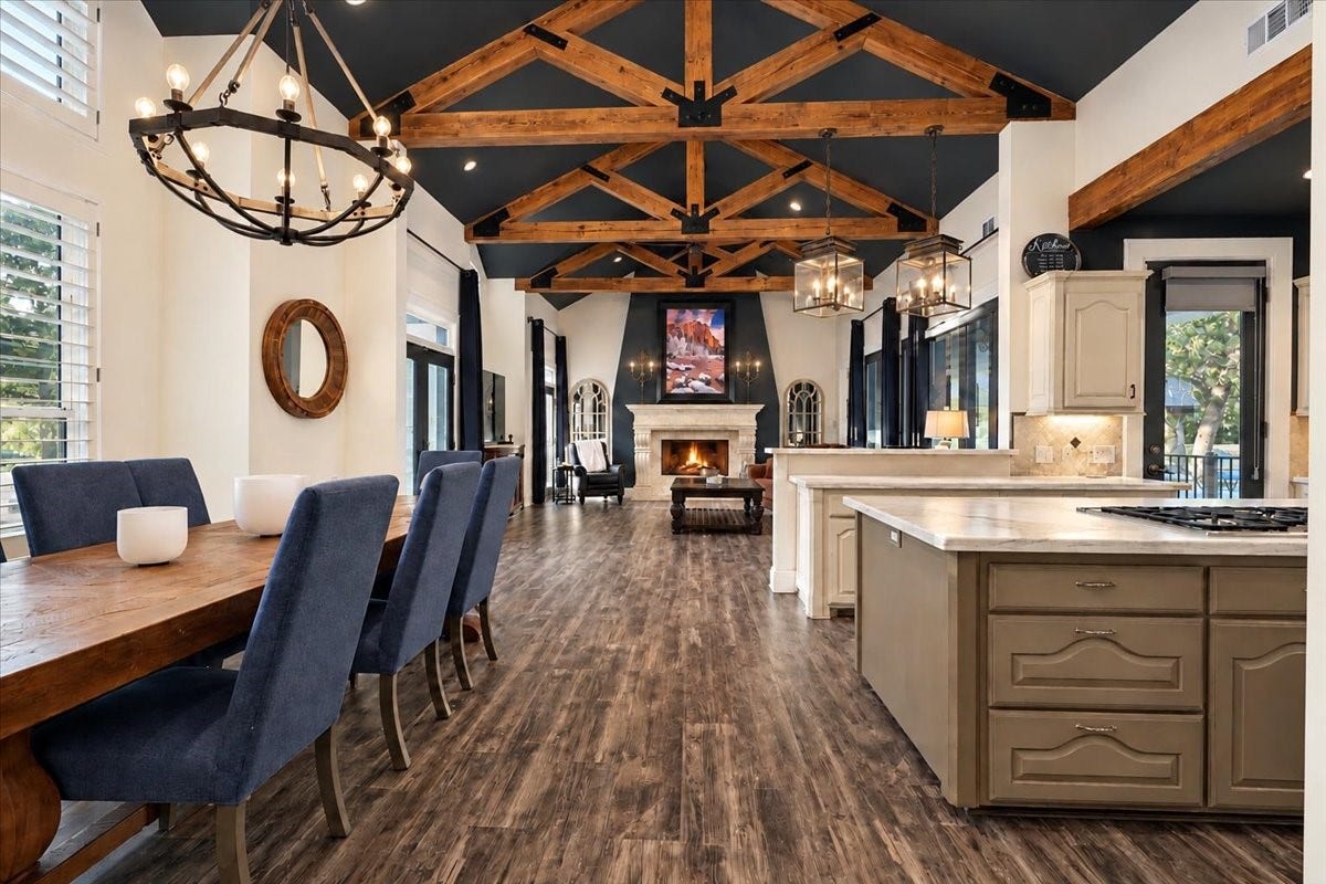 8514 Haven Way, Tomball, TX 77375 Seamless connectivity defines this main living space. The open layout connects the kitchen, breakfast area, and living room, with natural light and views of the fireplace that make everyday meals and holiday gatherings feel welcoming.
