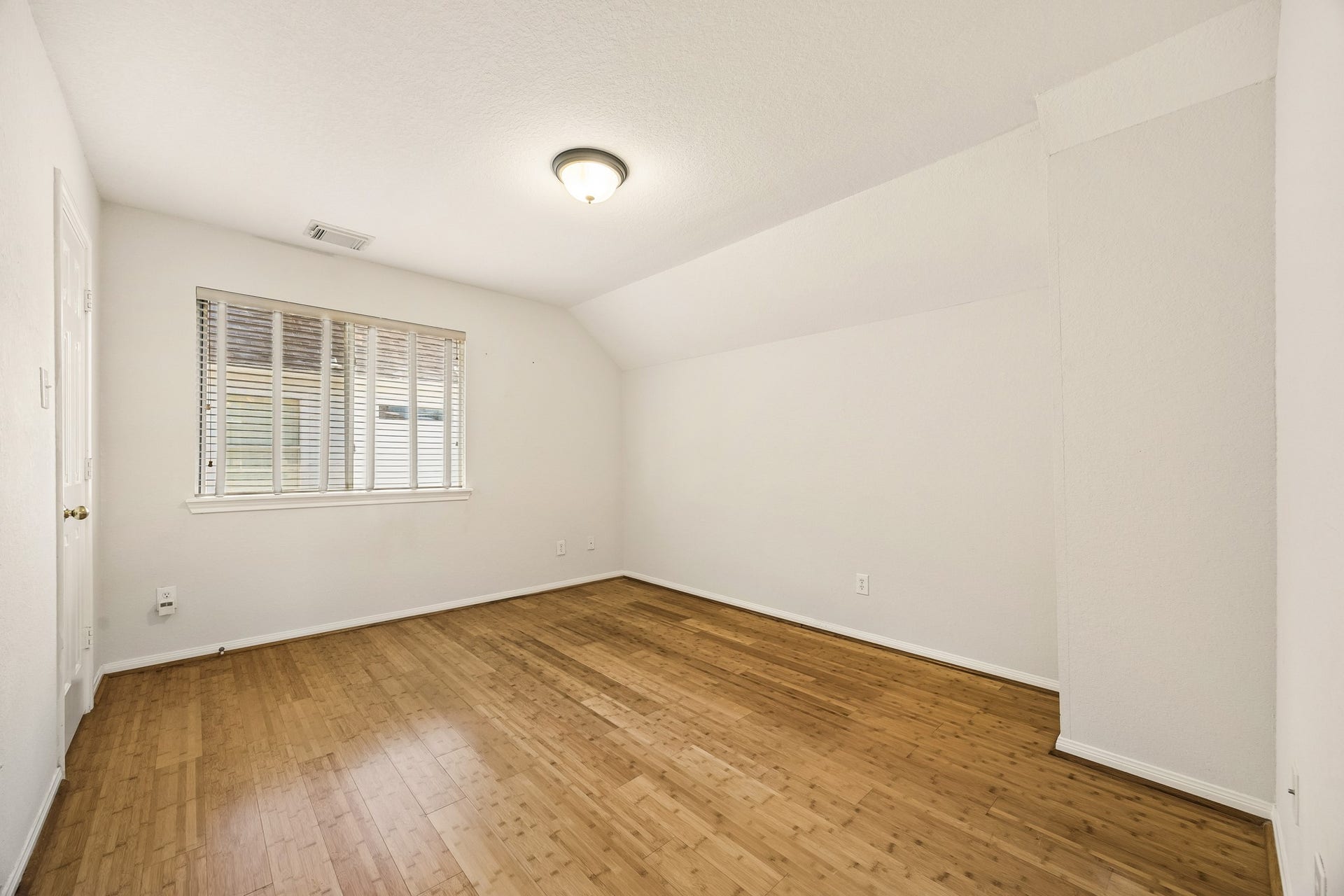 2843 Five Oaks Drive, Missouri City, TX 77459 One of three guest bedrooms upstairs, this comfortable space offers warm bamboo flooring, neutral paint and plenty of space to create an inviting retreat for family or overnight guests.