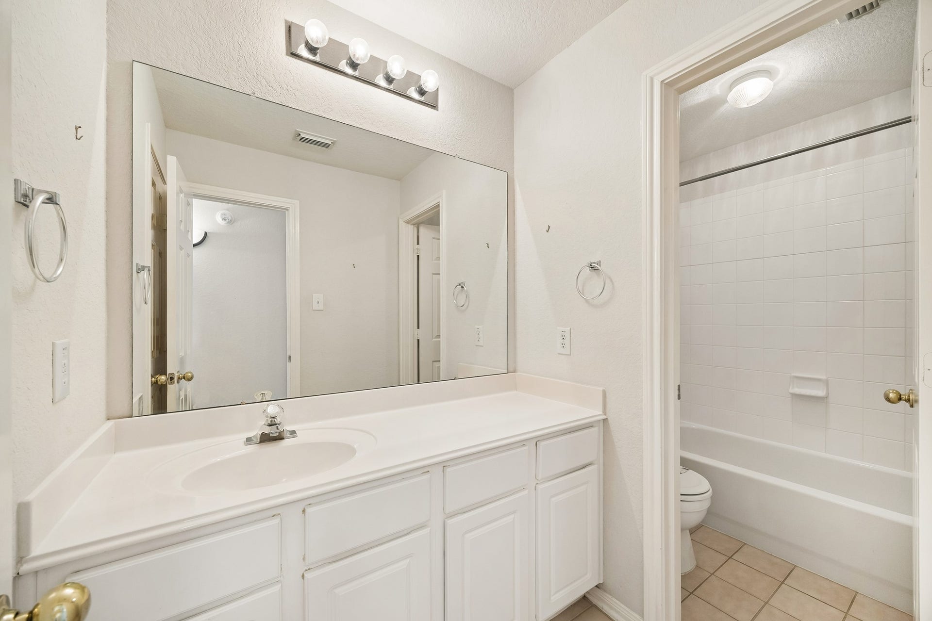 2843 Five Oaks Drive, Missouri City, TX 77459 The upstairs guest bathroom keeps daily routines simple with a long vanity, ample counter space, bright lighting and a private water closet with a convenient tub and shower combination.
