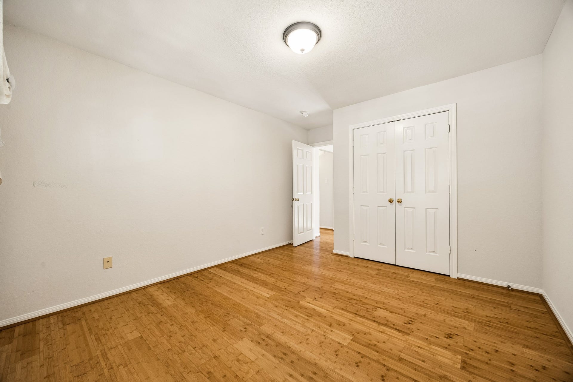 2843 Five Oaks Drive, Missouri City, TX 77459 Guest bedroom number two keeps things comfortable and easy with warm bamboo flooring, a neutral color palette, a large closet and convenient access to the nearby full bathroom.