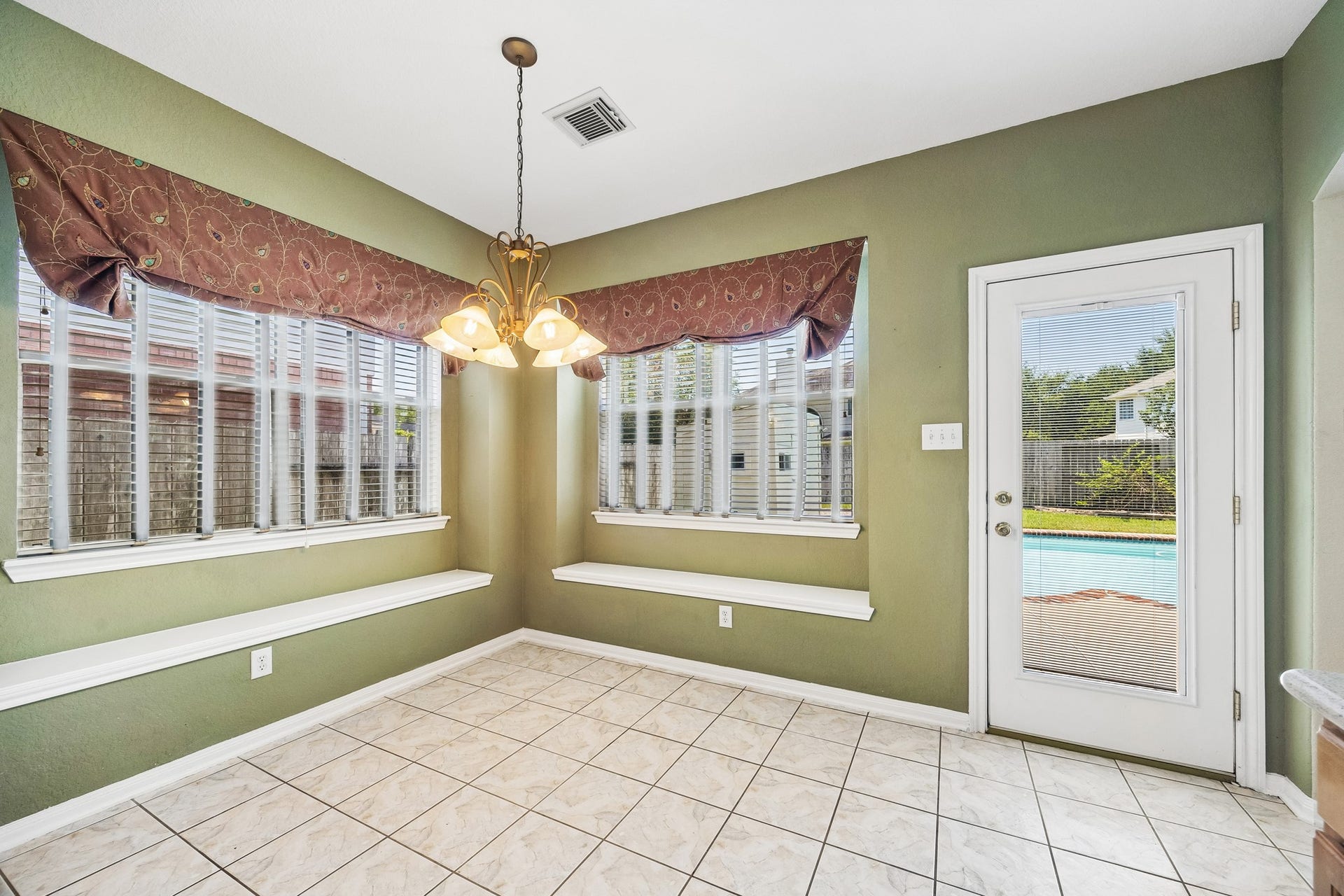 2843 Five Oaks Drive, Missouri City, TX 77459 Breakfast comes with a backyard view in this sunny dining area, where corner windows, built-in seating and direct access to the patio and pool make it easy to move from everyday meals to outdoor fun.