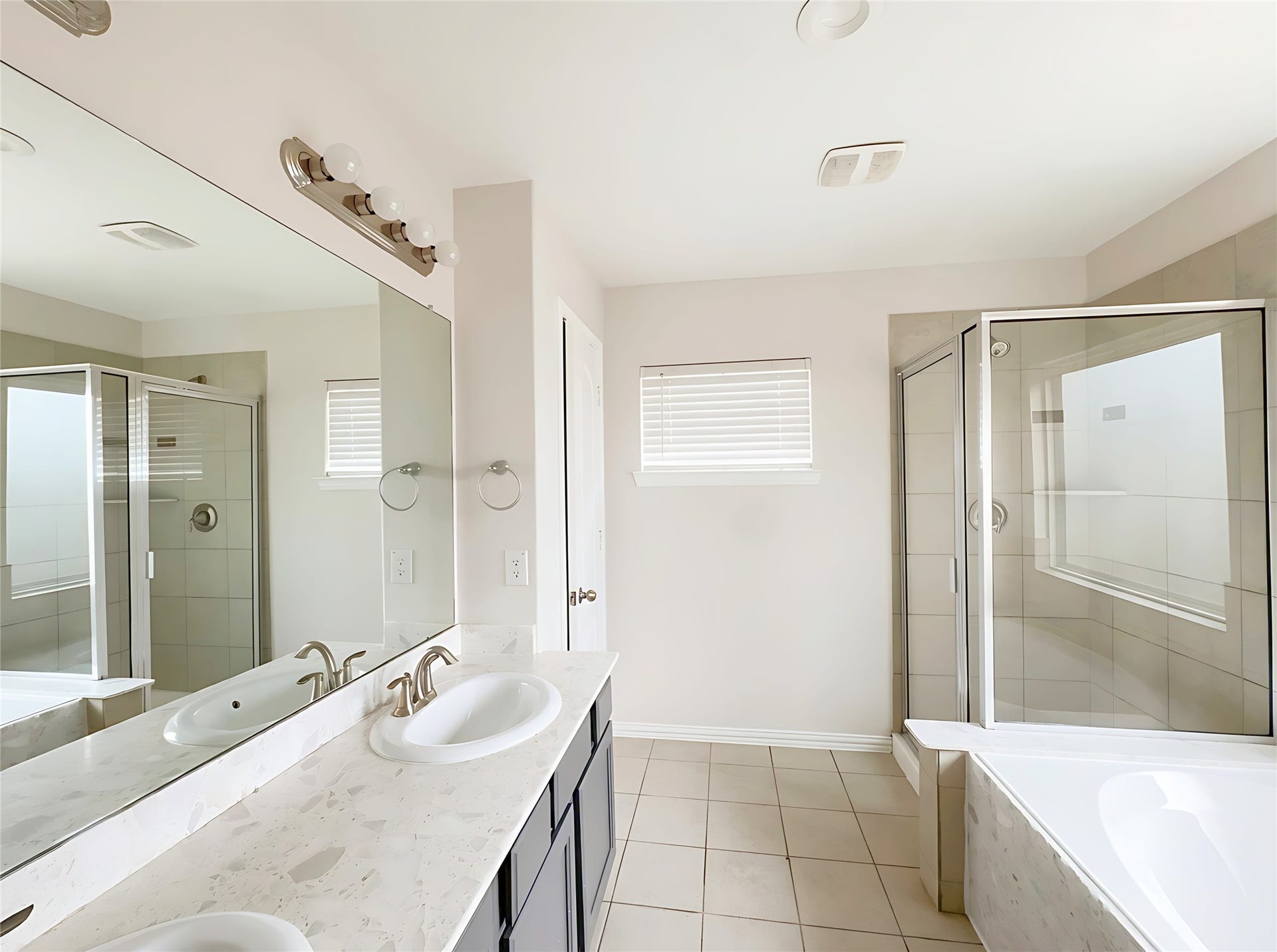 662 W Linnwood Drive, Woodbranch, TX 77357 Primery Bathroom - 2st Floor - double vanity with sleek countertops, a spacious glass-enclosed shower, and a luxurious soaking tub