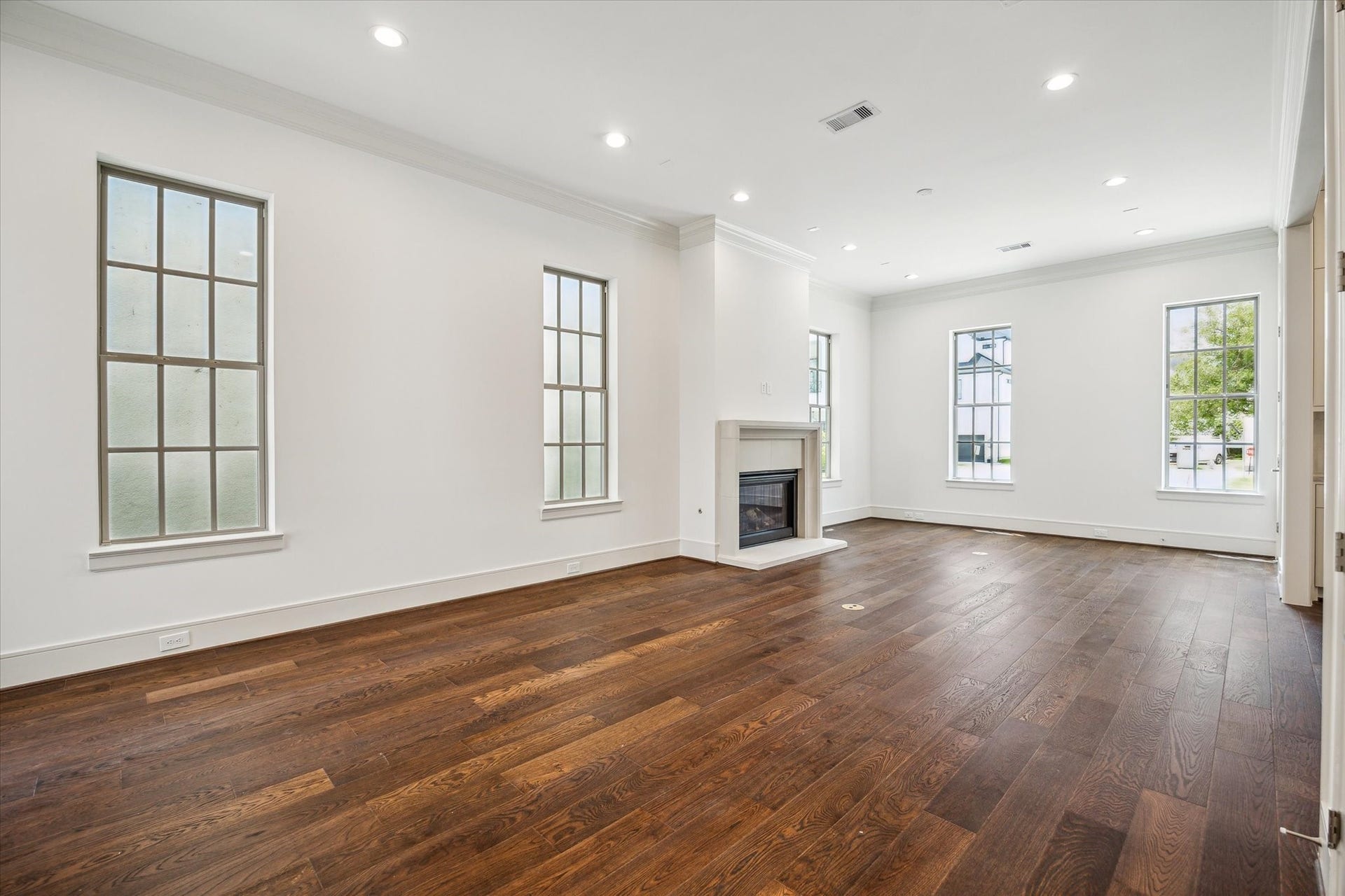 209 Sutton Row Place, Houston, TX 77024 Living Room features cast stone fireplace and wonderful natural light from ample windows.