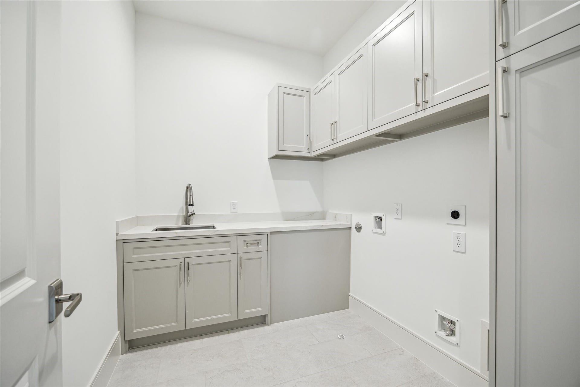 209 Sutton Row Place, Houston, TX 77024 Second-floor utility room features sink and cabinet storage.