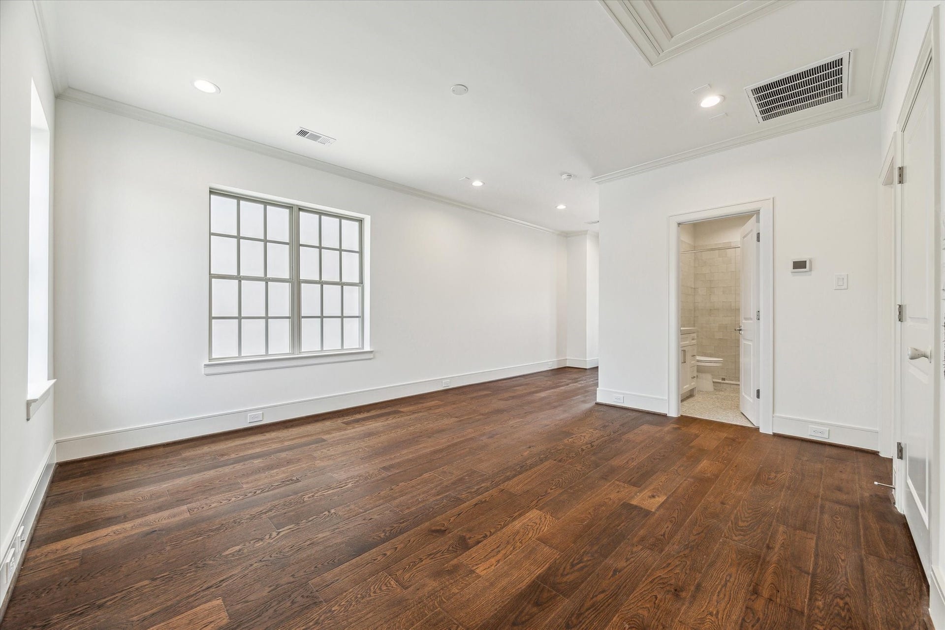 209 Sutton Row Place, Houston, TX 77024 Third-floor game room, access to balcony through glass door on left, secondary bedroom through middle door on right.