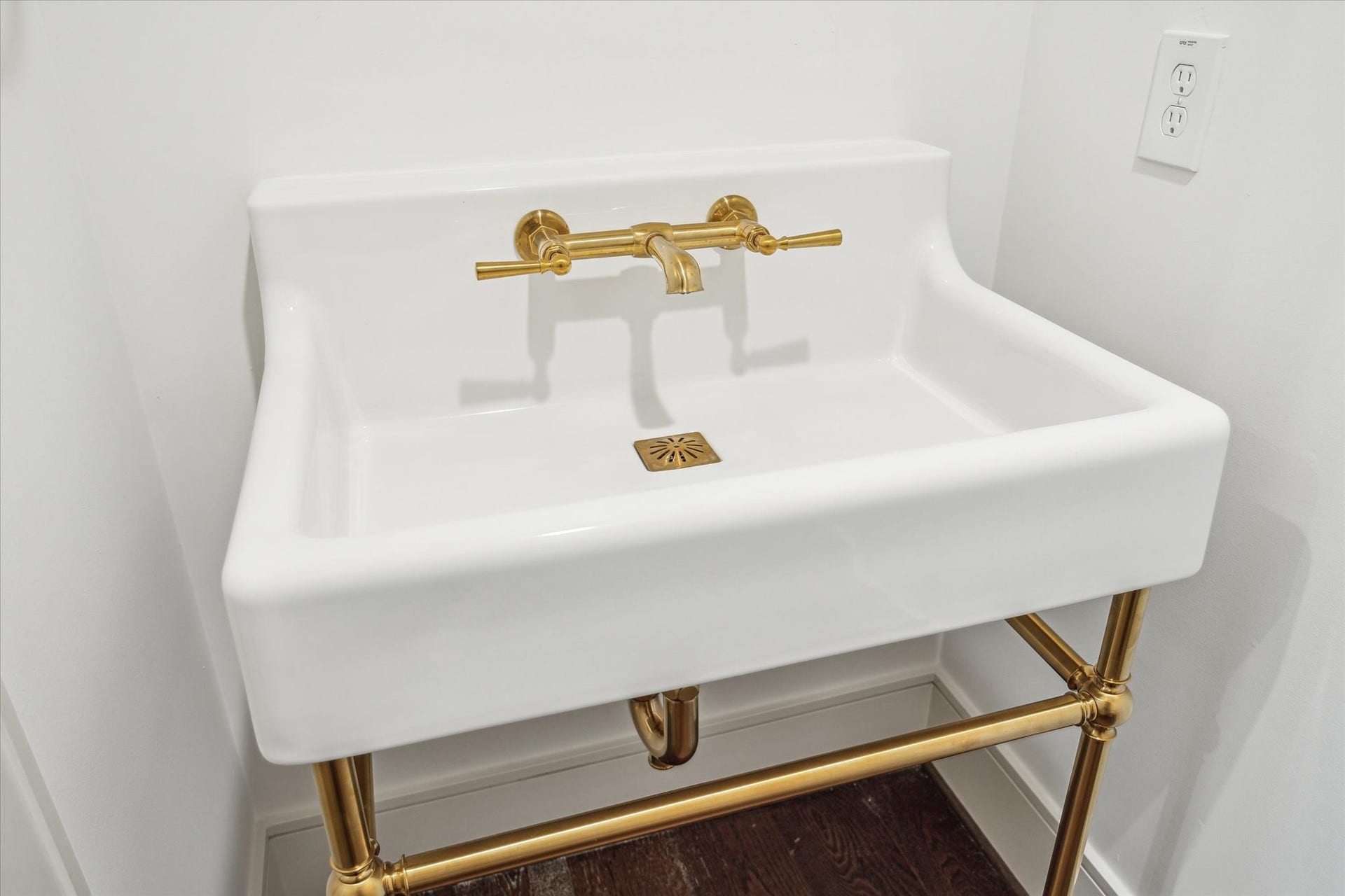 209 Sutton Row Place, Houston, TX 77024 Powder Bath features console sink with brass details.