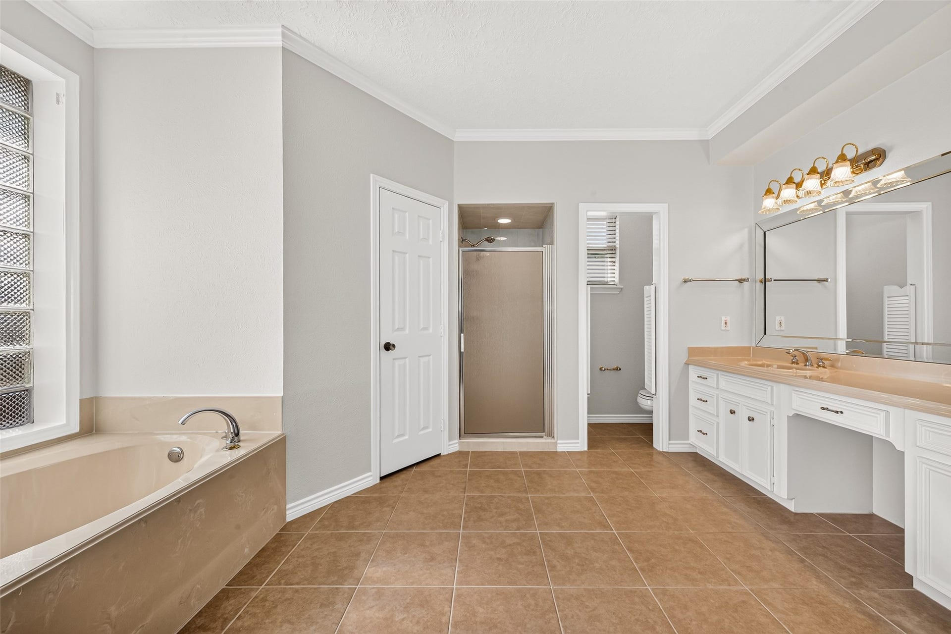 DESIGNED FOR EVERYDAY CONVENIENCE! The primary bathroom offers a practical layout with two separate vanities, a garden tub & a walk-in tiled shower. Having dedicated spaces for getting ready makes busy mornings a little easier, while the garden tub provides a comfortable place to unwind at the end of the day. A private water closet adds another thoughtful touch to this functional ensuite bathroom.