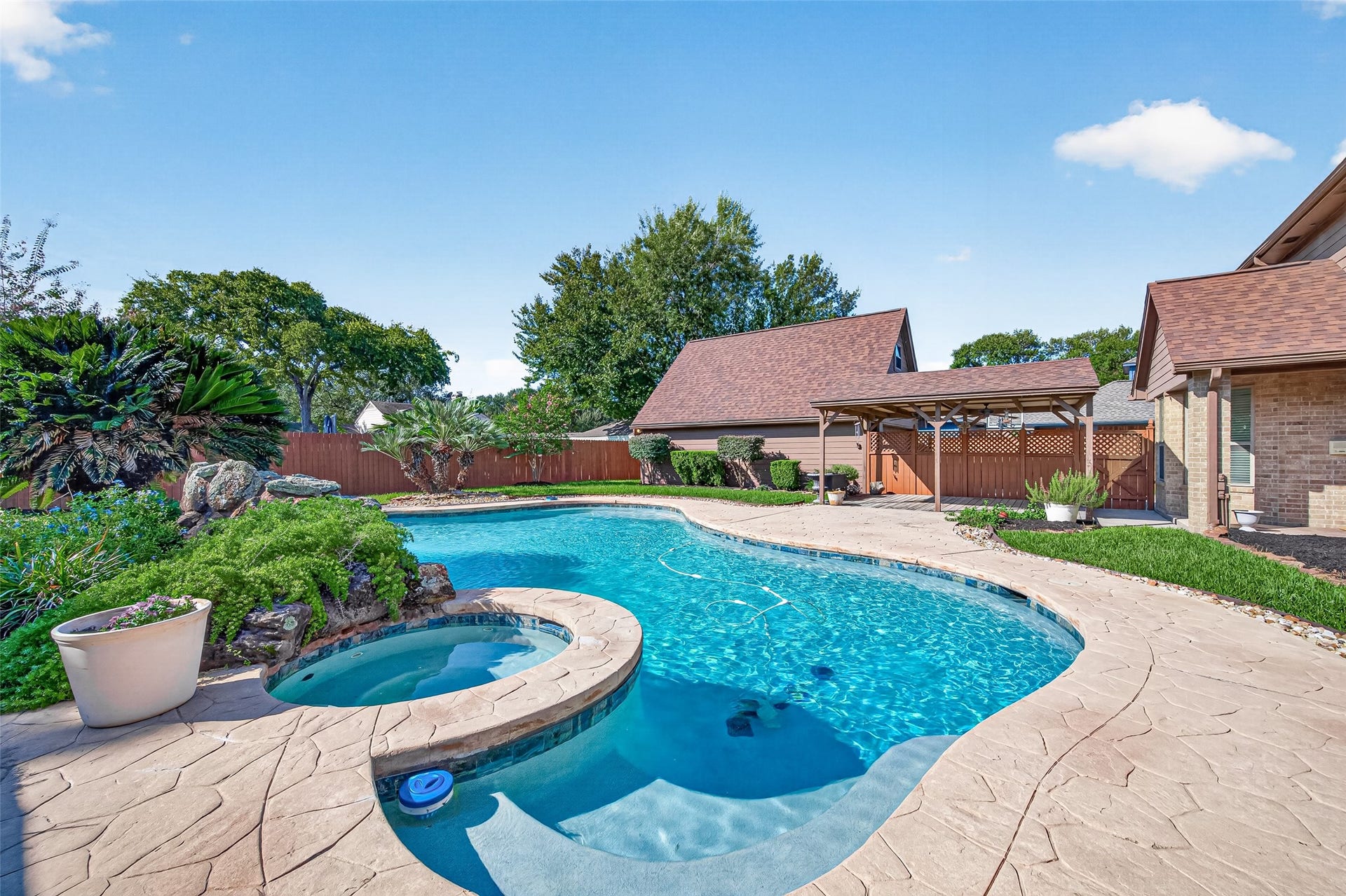 YOUR OWN PRIVATE BACKYARD PARADISE! Picture yourself floating in the sparkling pool on a warm Texas afternoon, relaxing in the heated spa or enjoying the soothing sounds of the waterfall. The spacious covered wooden deck with ceiling fans is perfect for outdoor dining, weekend BBQs or simply unwinding with your favorite beverage. Beautiful landscaping & grassy yard with room for the family dog complete this wonderful outdoor retreat. WHO'S READY FOR A POOL PARTY?