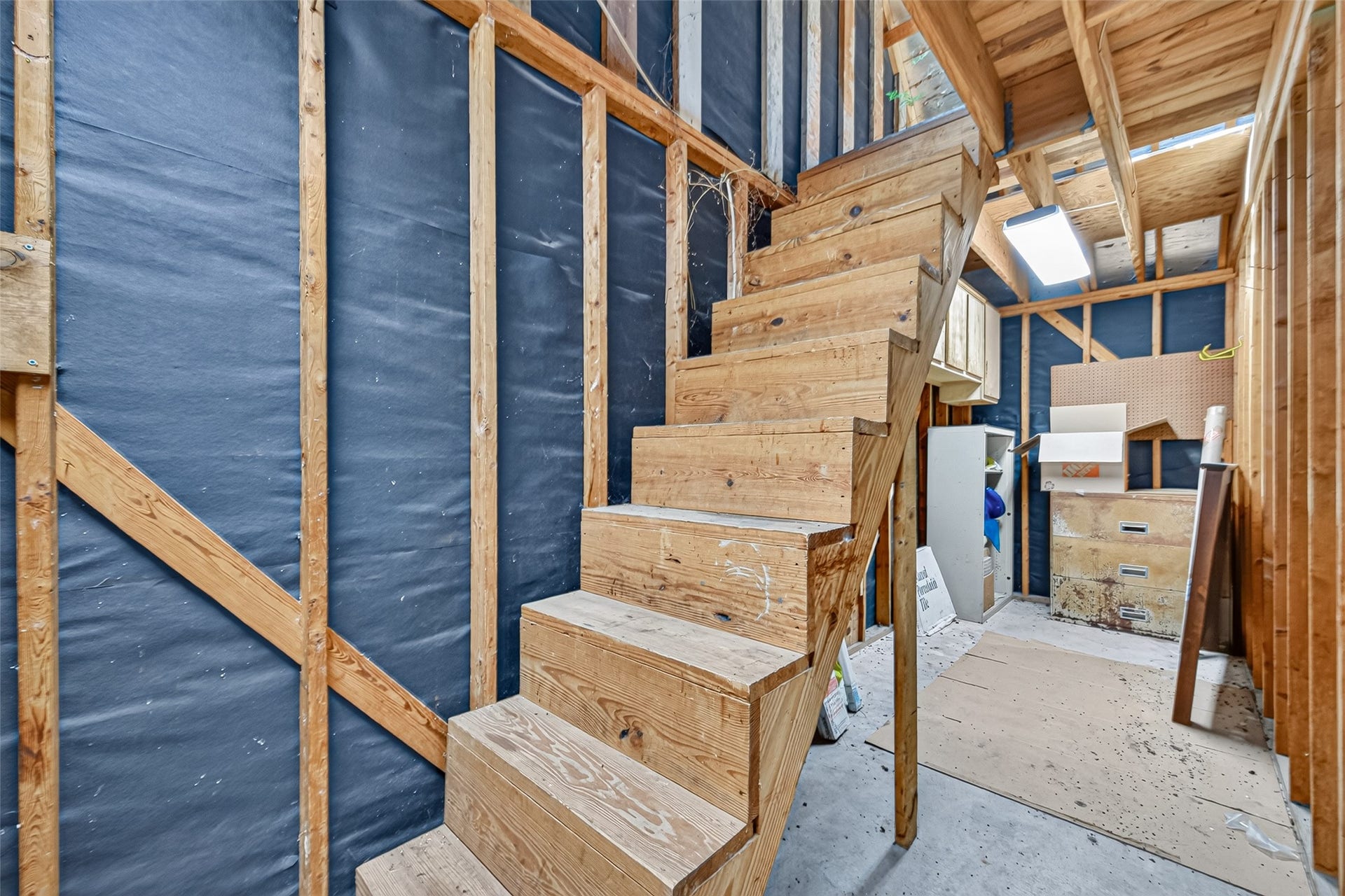 MORE THAN JUST A 2-CAR GARAGE! This oversized detached garage offers plenty of room for parking, plus a workshop or additional storage area tucked away at the rear. Whether you enjoy tackling DIY projects, working on hobbies or simply having a place to organize tools & equipment, the extra space is a welcome bonus! And there's MORE! A wooden staircase leads to an extensive floored storage area above the garageperfect for keeping seasonal items & belongings out of the way. WATCH YOUR STEP!