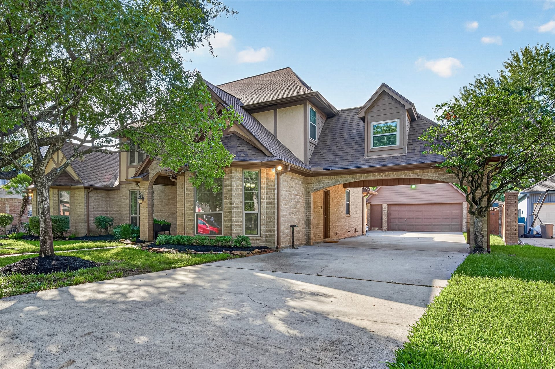 ROOM FOR YOUR CARS & SO MUCH MORE! The spacious driveway leads to a drive-through porte cochere & oversized detached 2-car garage. Imagine pulling under the covered porte cochere on a rainy afternoon and carrying groceries directly into the utility room through the convenient side entrance. The garage offers workshop space & a staircase leading to a HUGE floored attic aboveperfect for storing holiday decorations, seasonal items & all those things you want to keep but don't need every day. STORAGE GALORE!