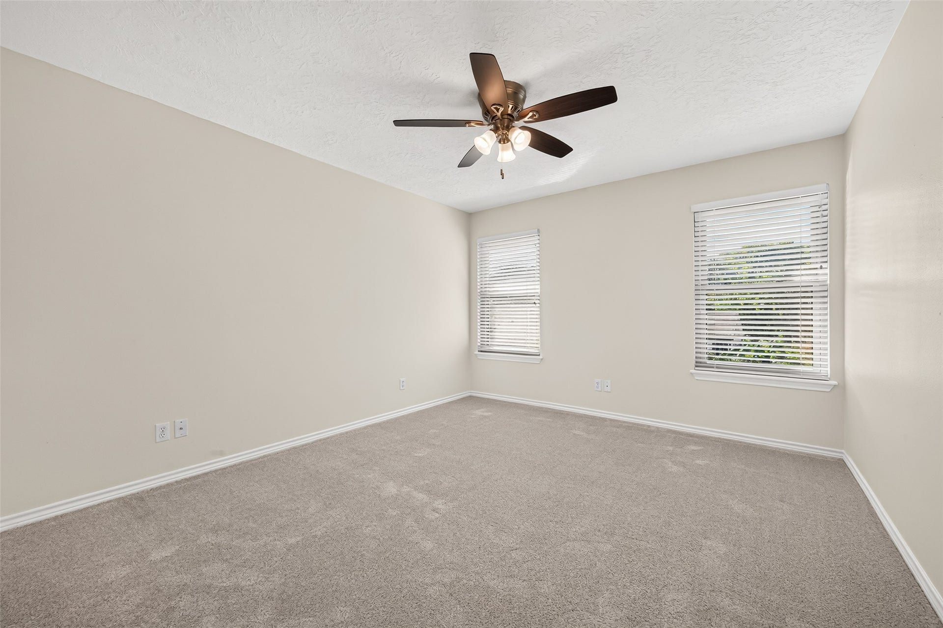 A COMFORTABLE RETREAT WITH A BACKYARD VIEW! Bedroom #2 is an inviting second-floor bedroom features windows overlooking the backyard pool, bringing in natural light & offering a lovely view of the outdoor retreat. A ceiling fan adds comfort, while the lighted walk-in closet provides convenient space for organizing clothing, shoes & personal belongings. Whether furnished as a bedroom, guest retreat or a combination bedroom & study space, there's plenty of opportunity to make this room your own.