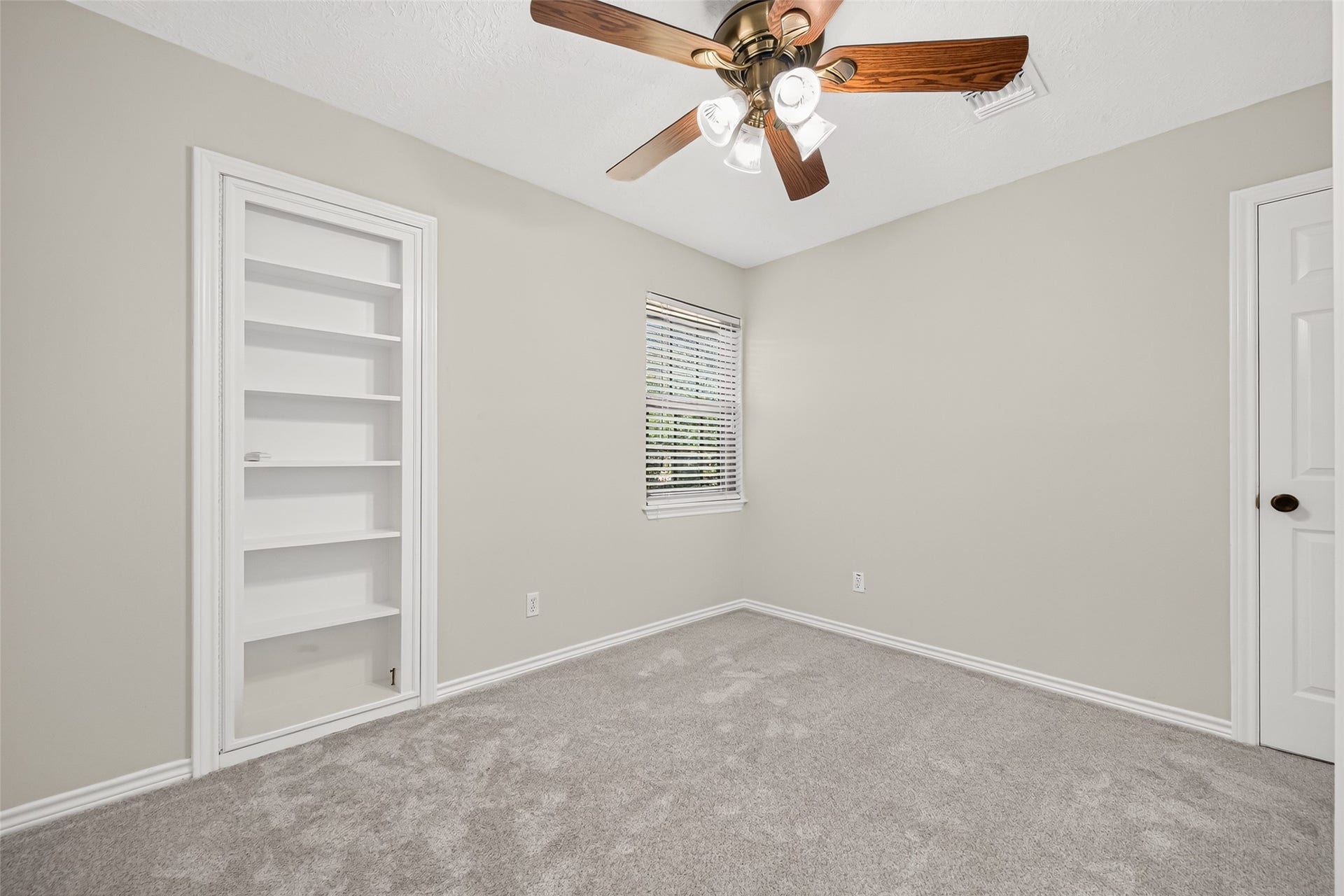 A HIDDEN SURPRISE BEHIND THE BOOKCASE! Bedroom #4 offers more than meets the eye! This second-floor bedroom features a ceiling fan for added comfort & a lighted walk-in closet. But take a closer look at that bookcase! Hidden behind it is access to a TEXAS BASEMENTa spacious walk-in attic offering an abundance of additional storage! Imagine having a convenient place for holiday decorations, luggage, seasonal items & all those things you want to keep but perhaps don't need every day.