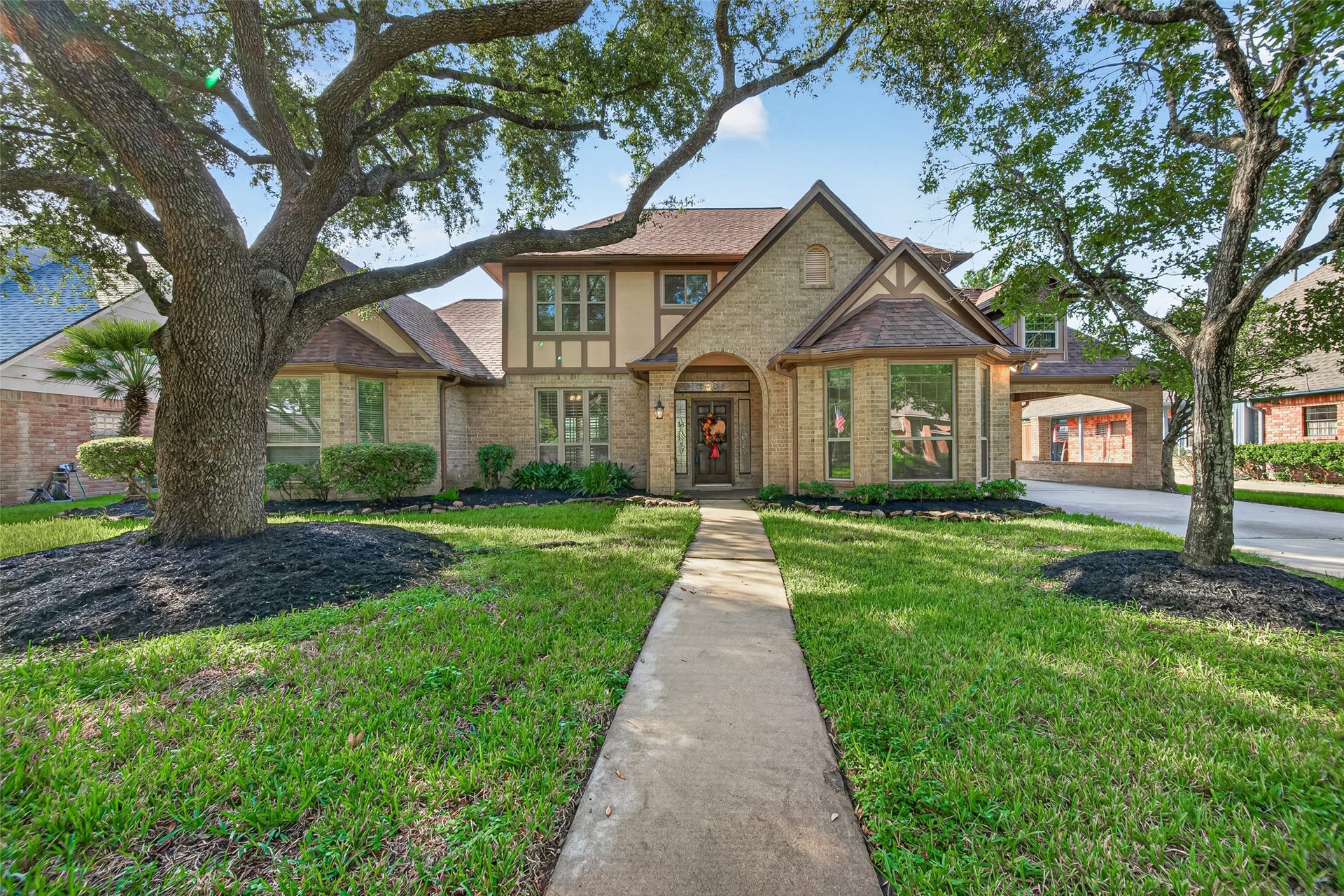 CHARMING ENGLISH TUDOR WITH SO MUCH TO OFFER! Framed by magnificent mature shade trees, this distinctive home features beautiful brickwork, Tudor-style architectural accents & welcoming curb appeal. Thoughtful improvements include a roof replaced in 2021, double-pane windows throughout, 2 HVAC systems & ductwork replaced in 2023, plus new attic insulation in 2023. Beautifully maintained landscaping & a full lawn sprinkler system add to the appeal.