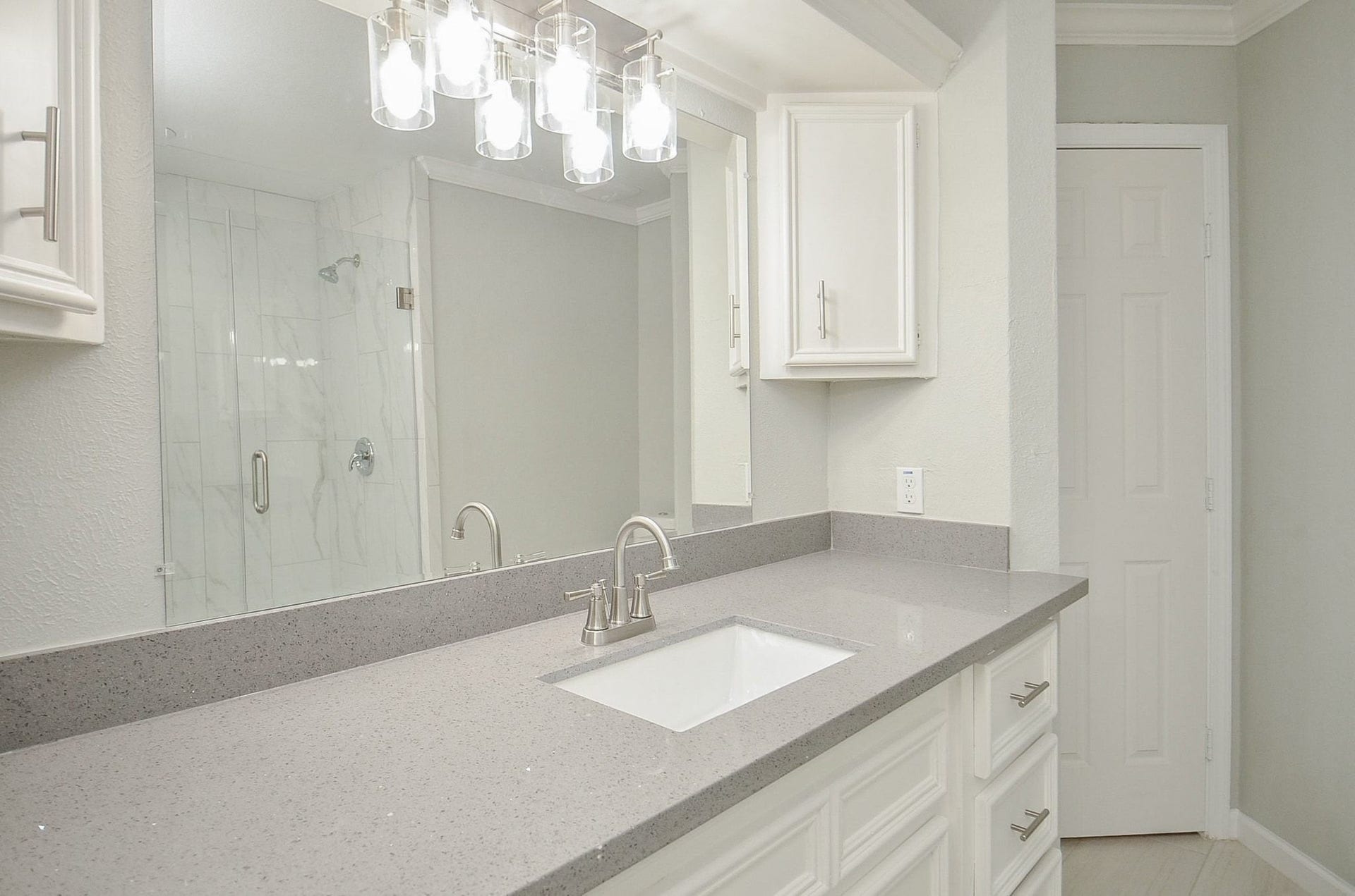29502 Stapleford Street, Spring, TX 77386 Countertops equipped with double sinks offering unlimited amounts of space. Notice the beautiful light fixture that hangs above the mirror.