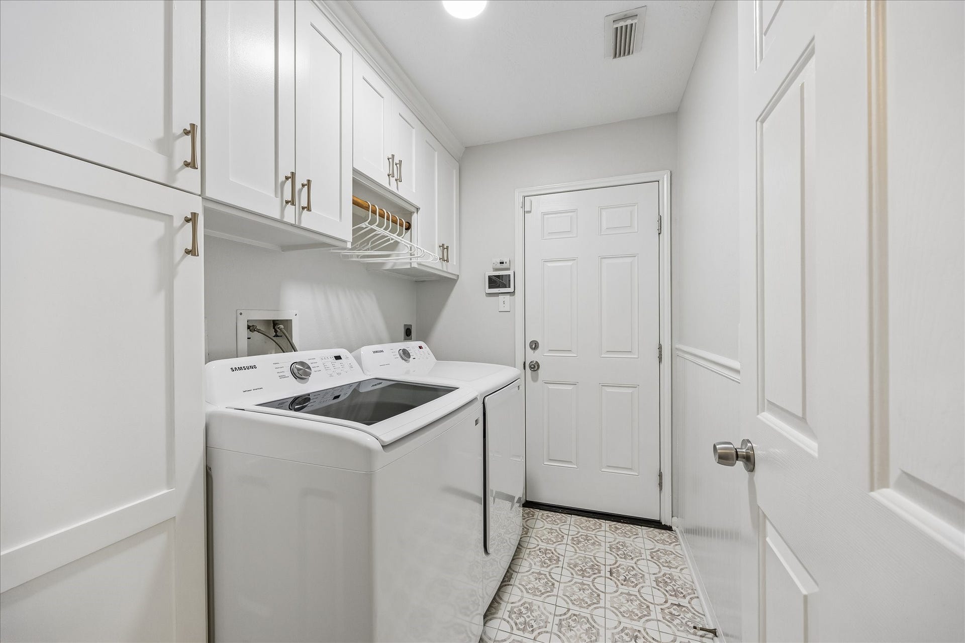 4114 Stonehurst Drive, Pearland, TX 77584 Who says a laundry room cant be beautiful? Thoughtfully upgraded with custom cabinetry, generous storage, and stylish tile flooring, this impressive utility room brings both organization and everyday convenience to a space thats often overlooked!