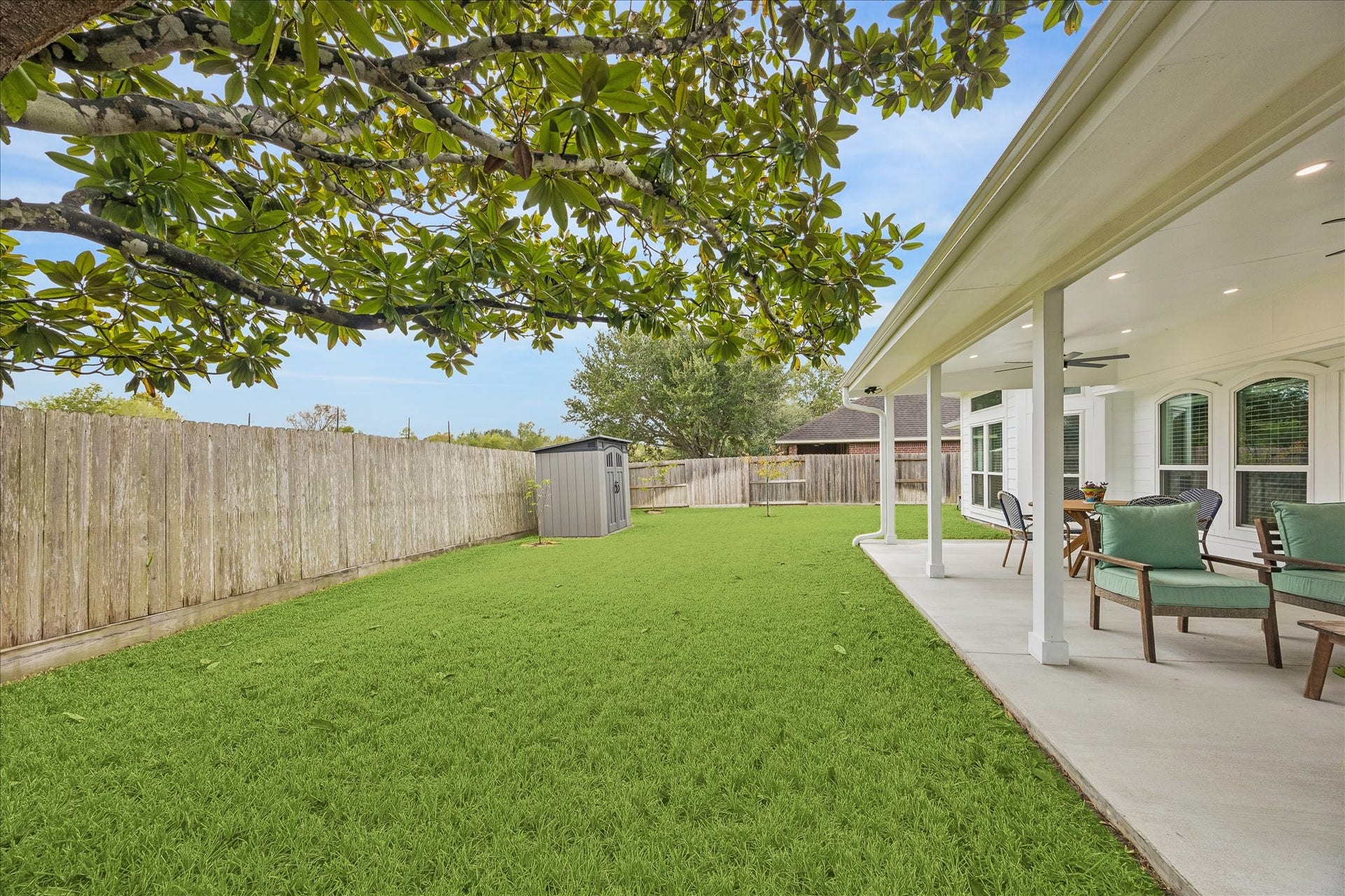 4114 Stonehurst Drive, Pearland, TX 77584 Your backyard oasis awaits! This beautiful view showcases the expansive covered patio and lush green lawn, offering plenty of space for outdoor dining, entertaining, or simply enjoying the peace and privacy of having no rear neighbors.