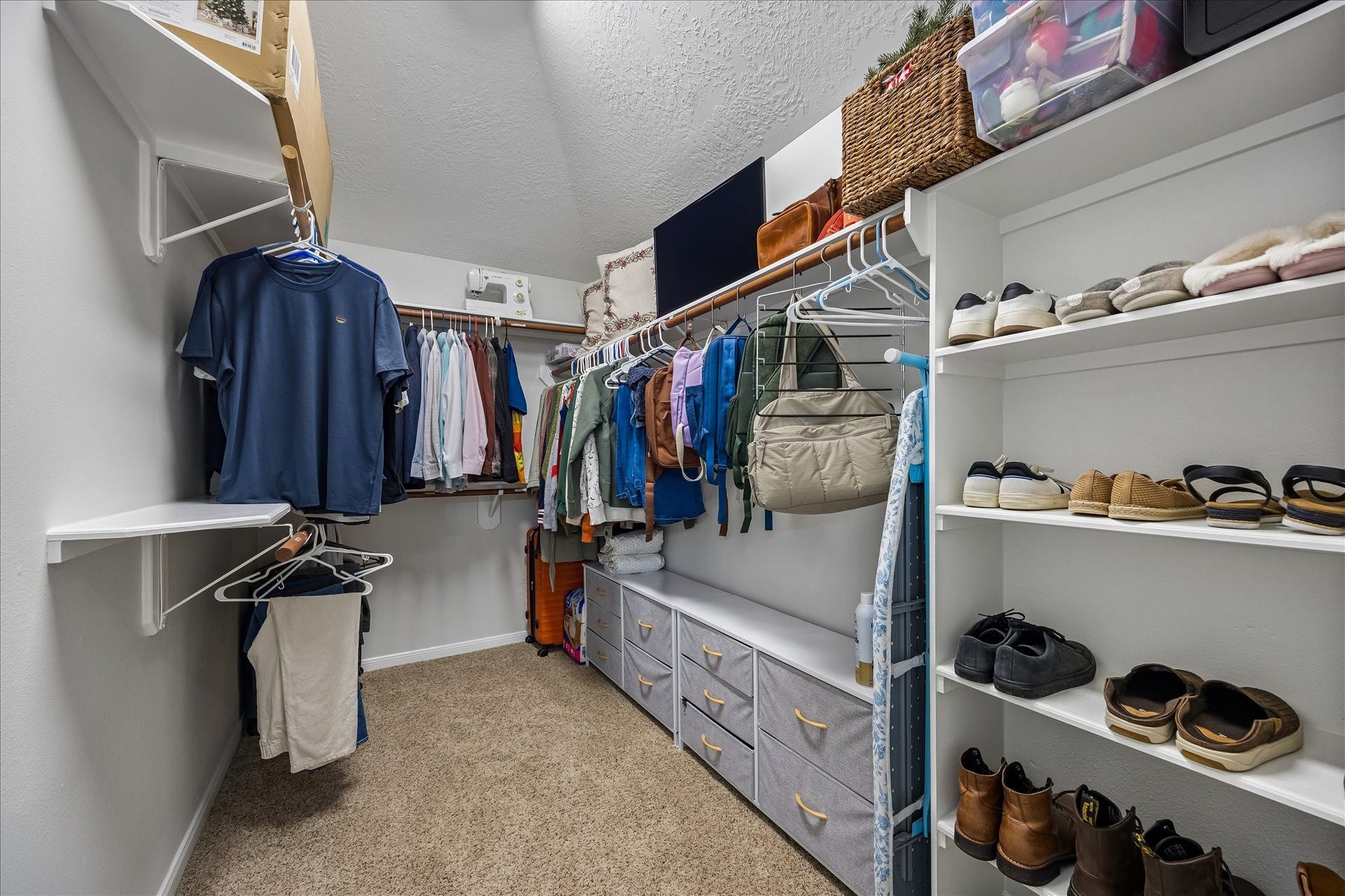 4114 Stonehurst Drive, Pearland, TX 77584 A place for everything! This generously sized primary walk-in closet offers abundant hanging space, shelving, and storage to keep your wardrobe beautifully organized and easily accessible.