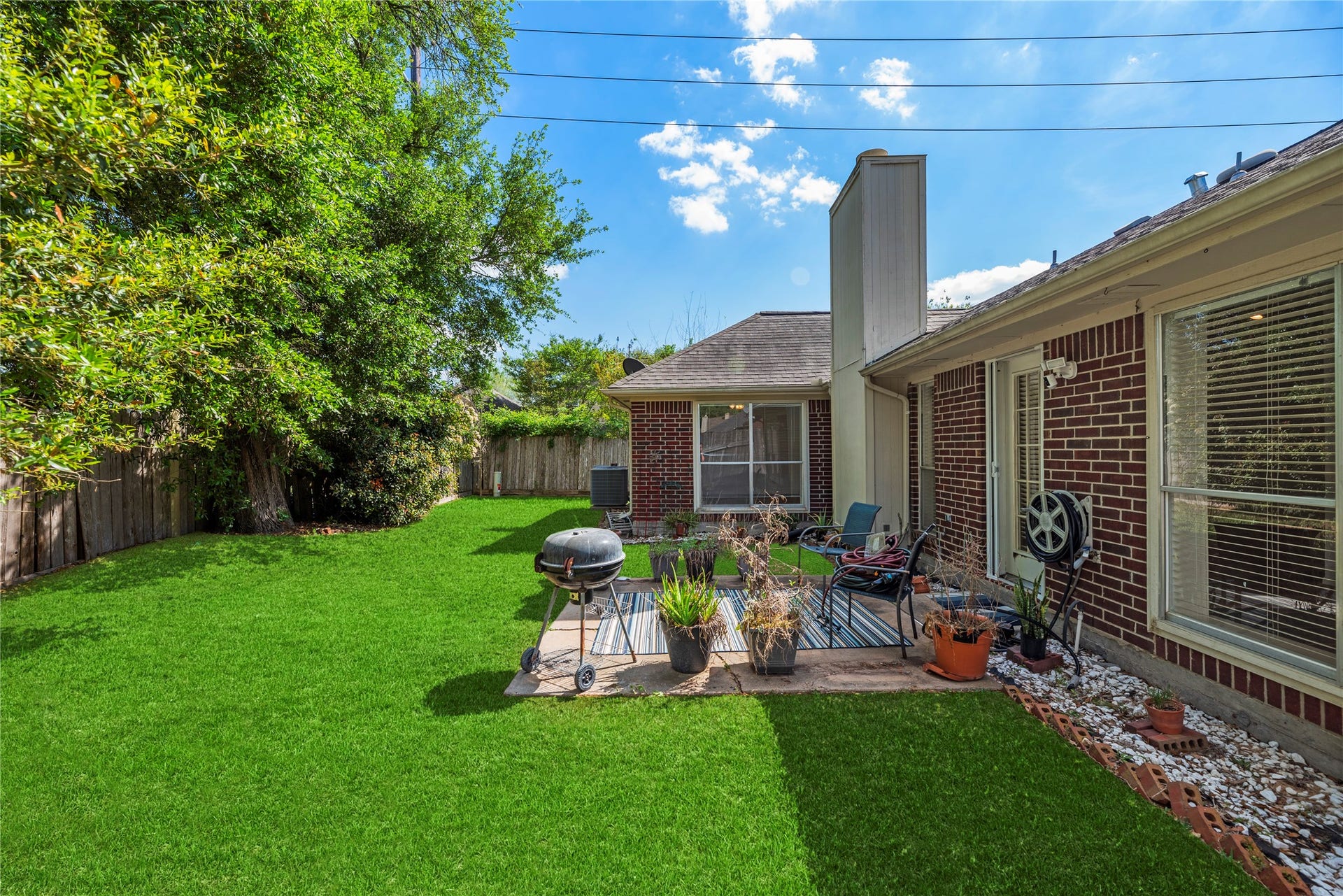 Spacious yard with a patio and brick on all four sides!