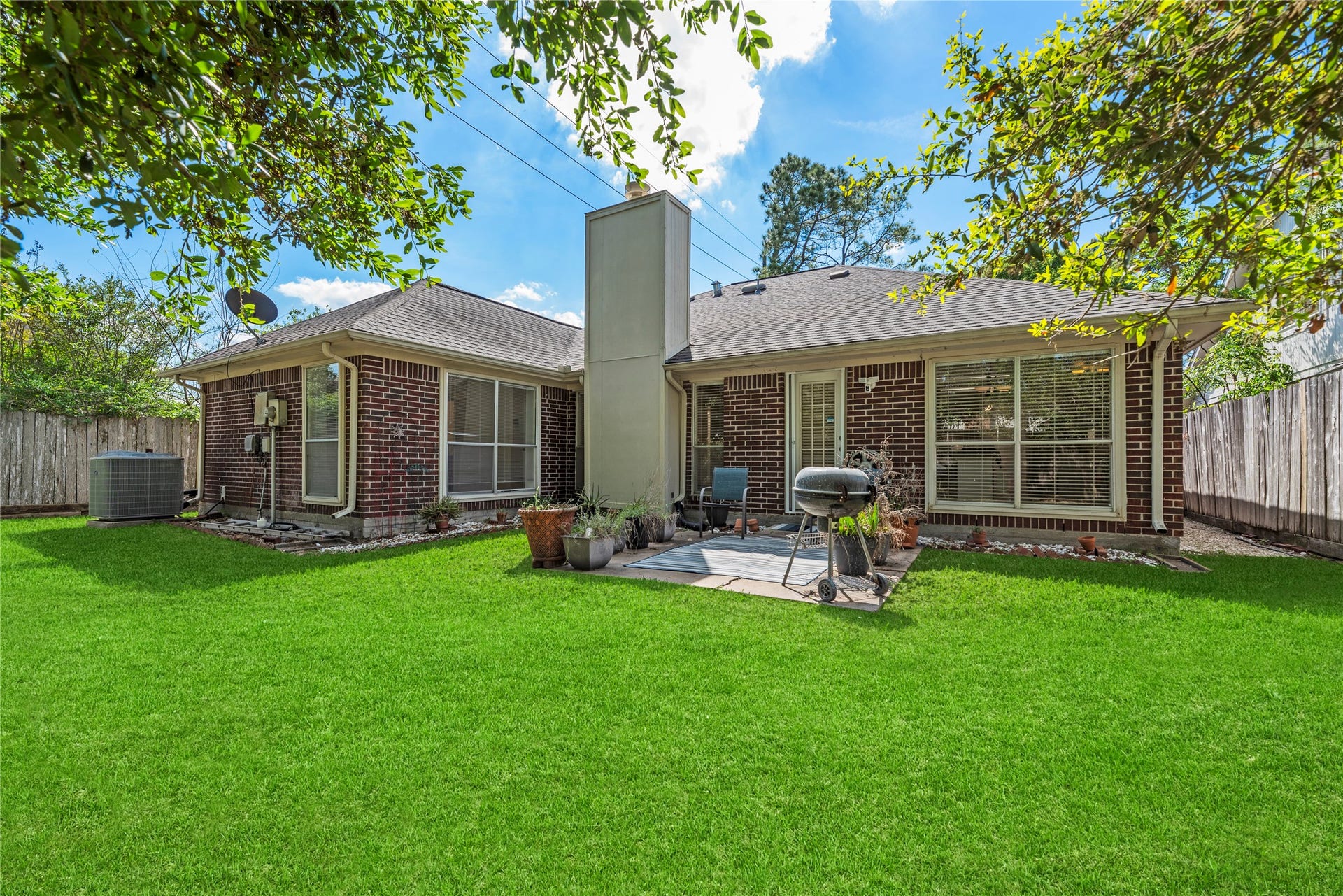 Spacious yard with a patio and brick on all four sides!
