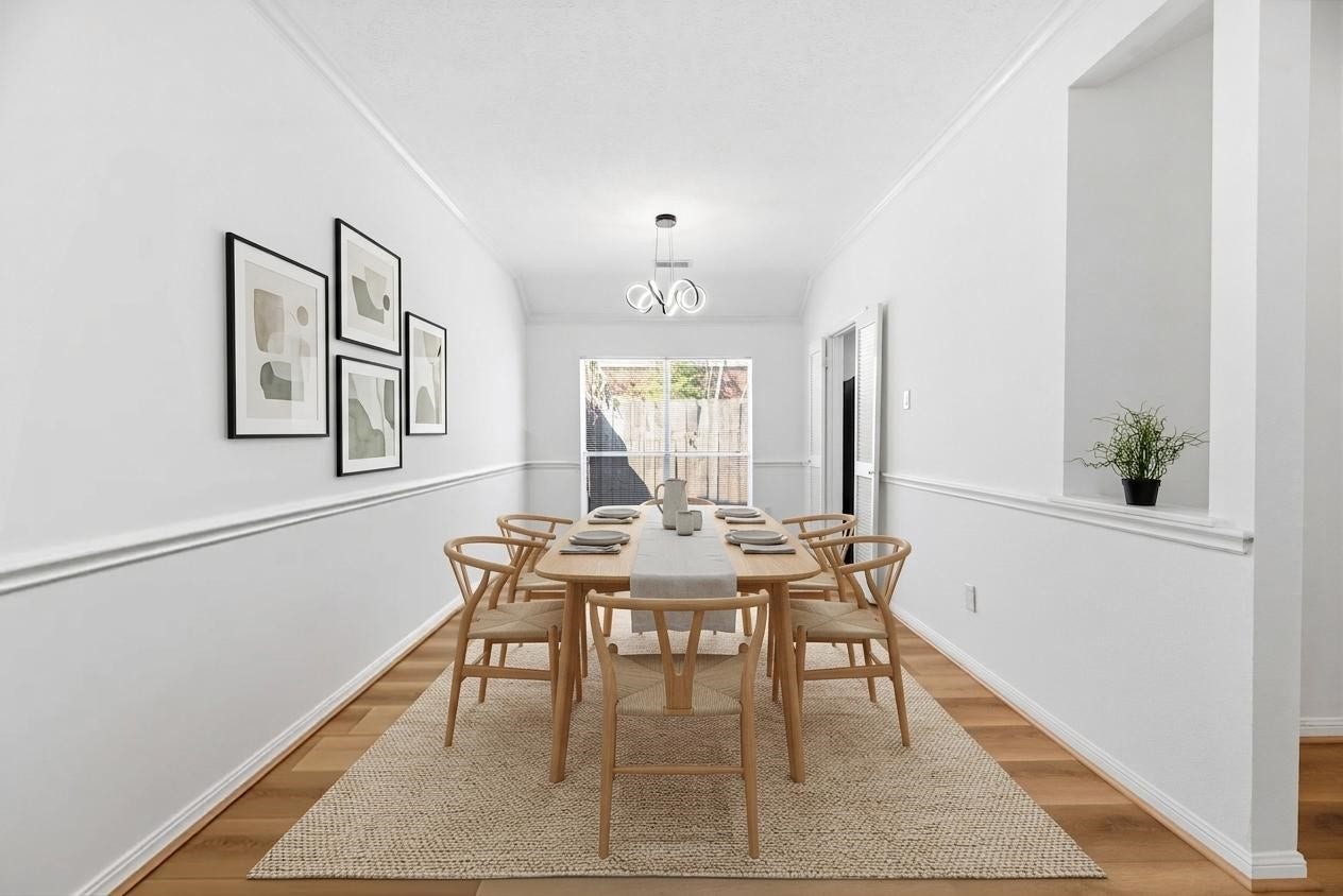 Spacious formal dining room with direct access to the kitchen in the front of the home. Sleek LVP floors, fresh paint, updated light fixture.