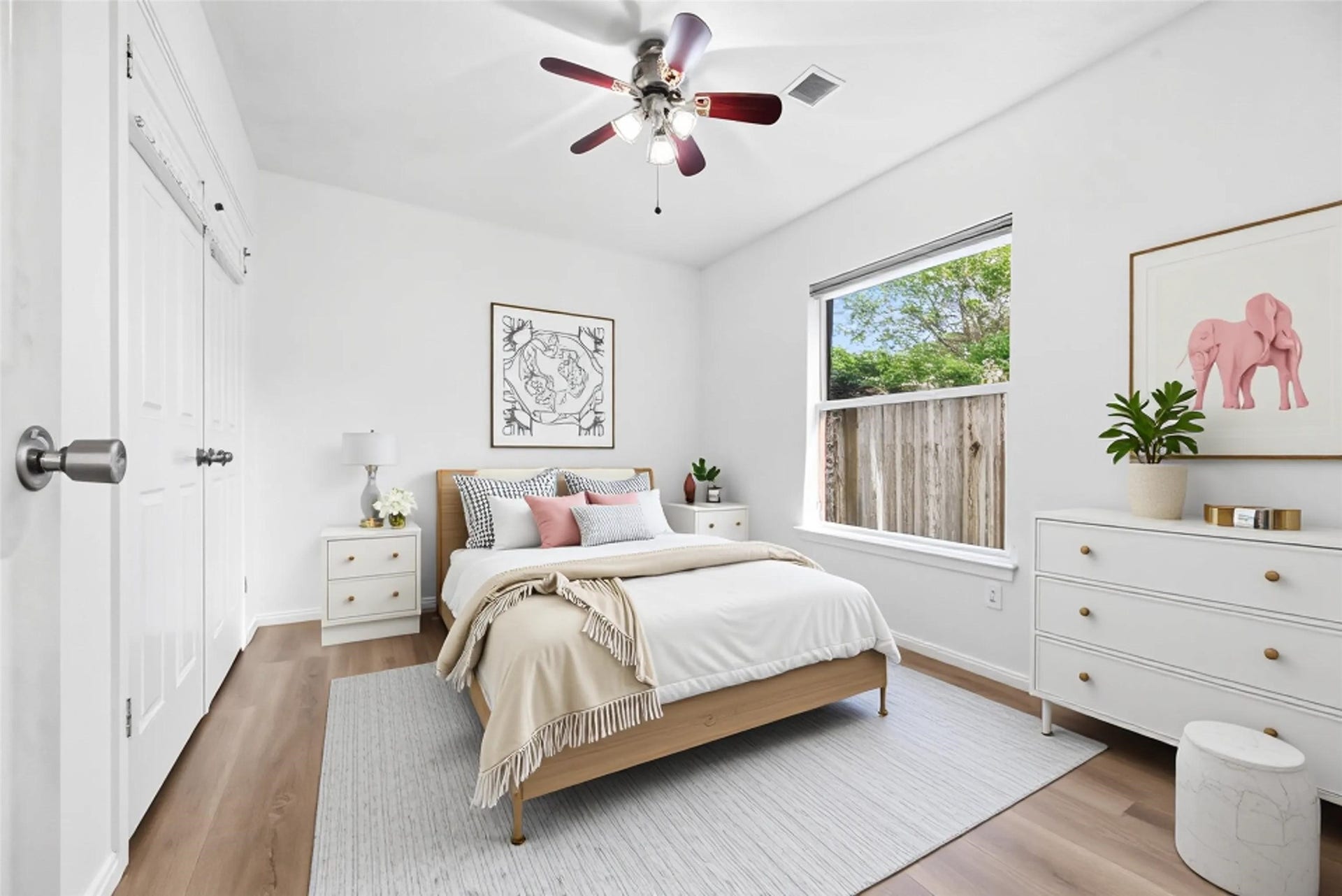 *virtually staged*Secondary bedroom complete with wide plank LVP floors, large window, and ceiling fan.
