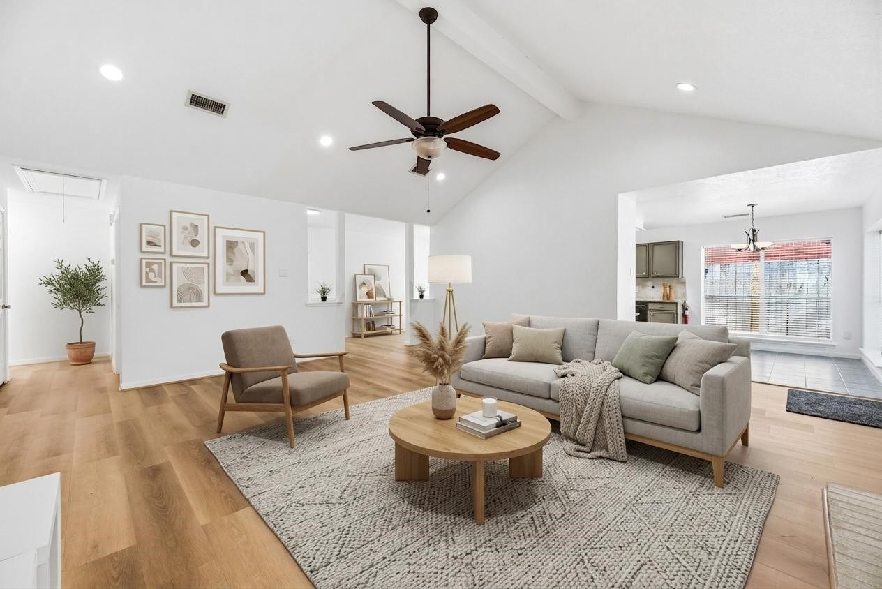 *virtually staged* shows the flow of the home from the entry and dining room into the living space.